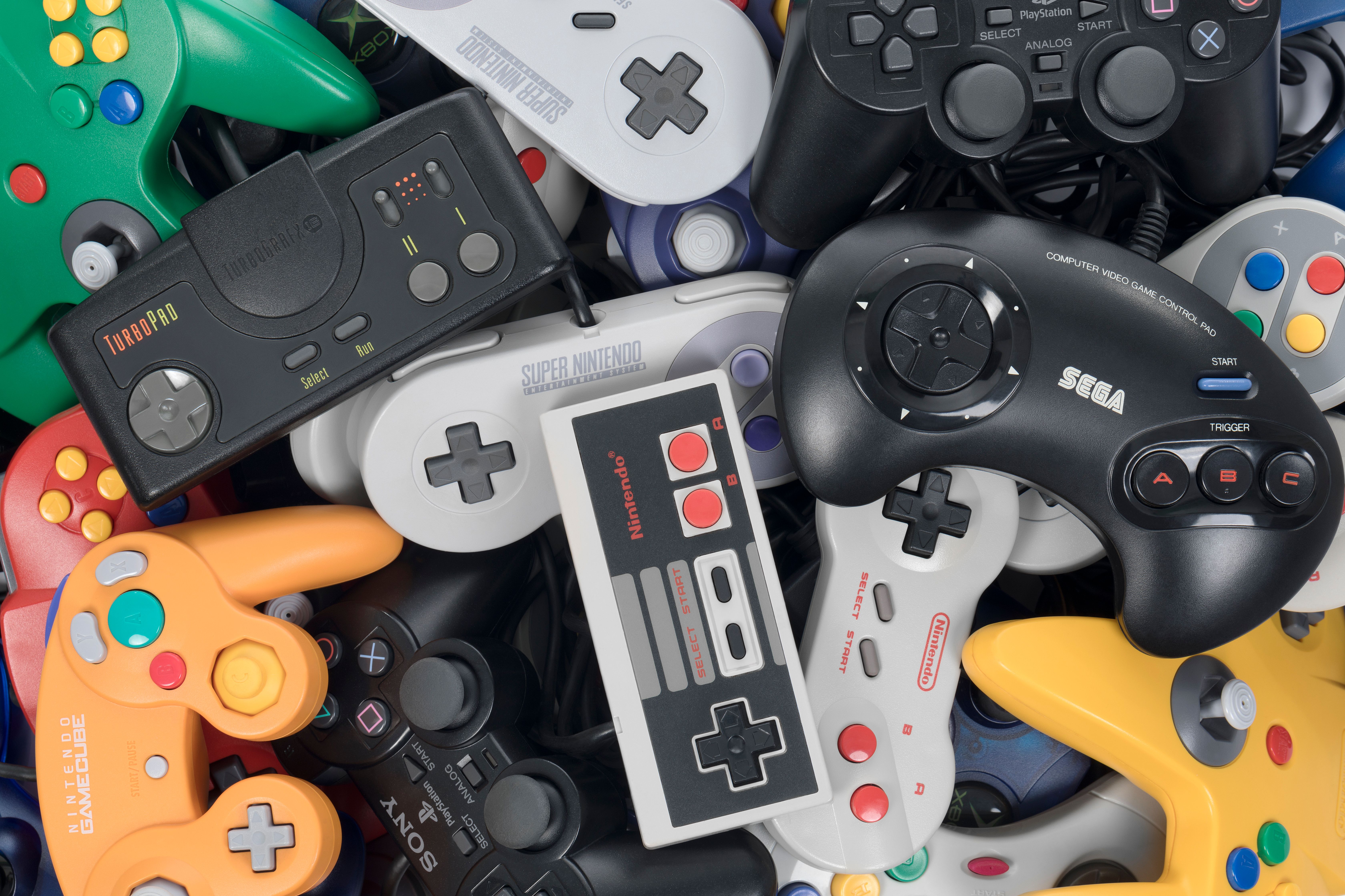 A pile of retro game controllers.
