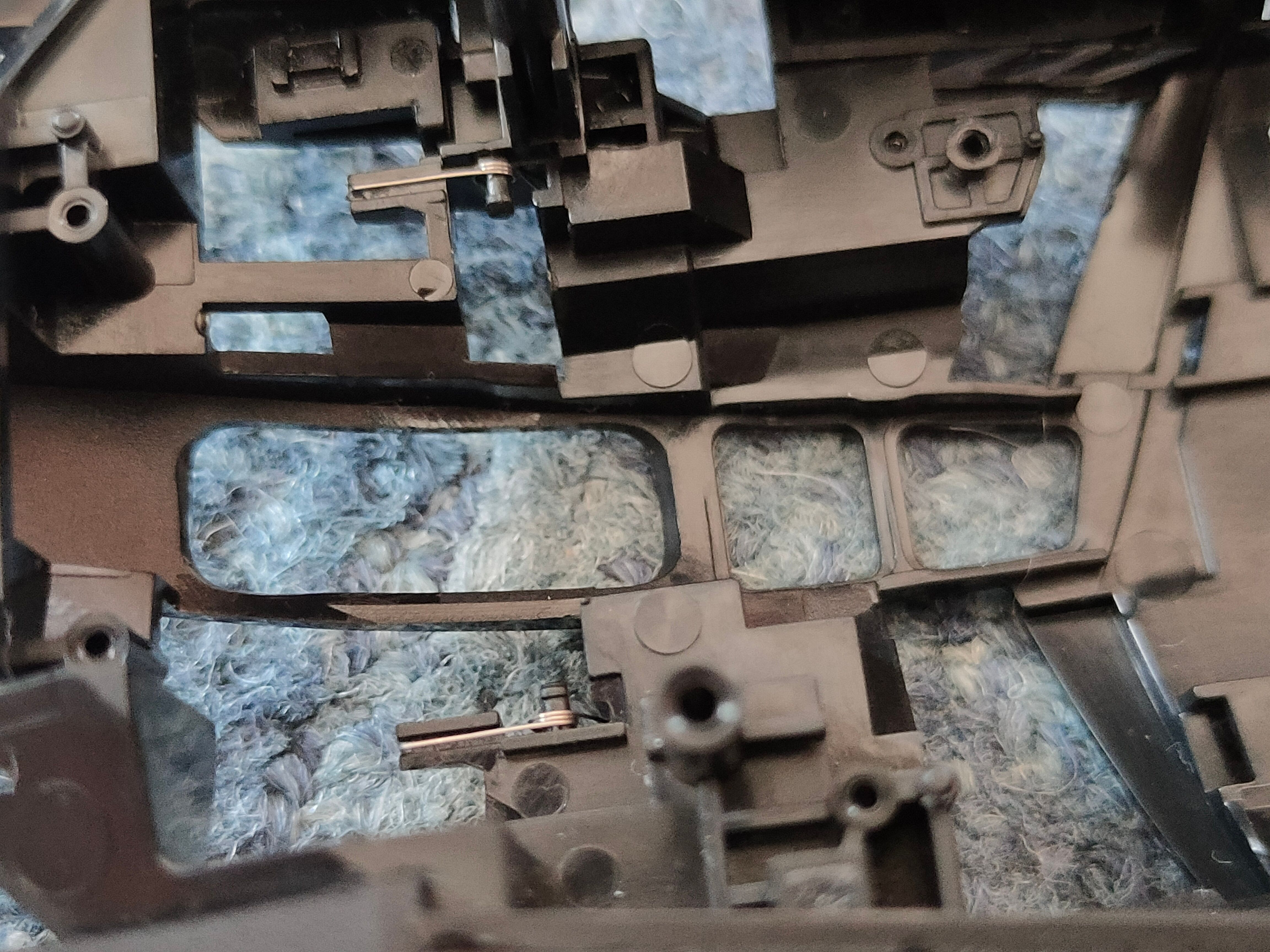 The tiny left and right mouse button springs inside of a Logitech G502 Lightspeed.