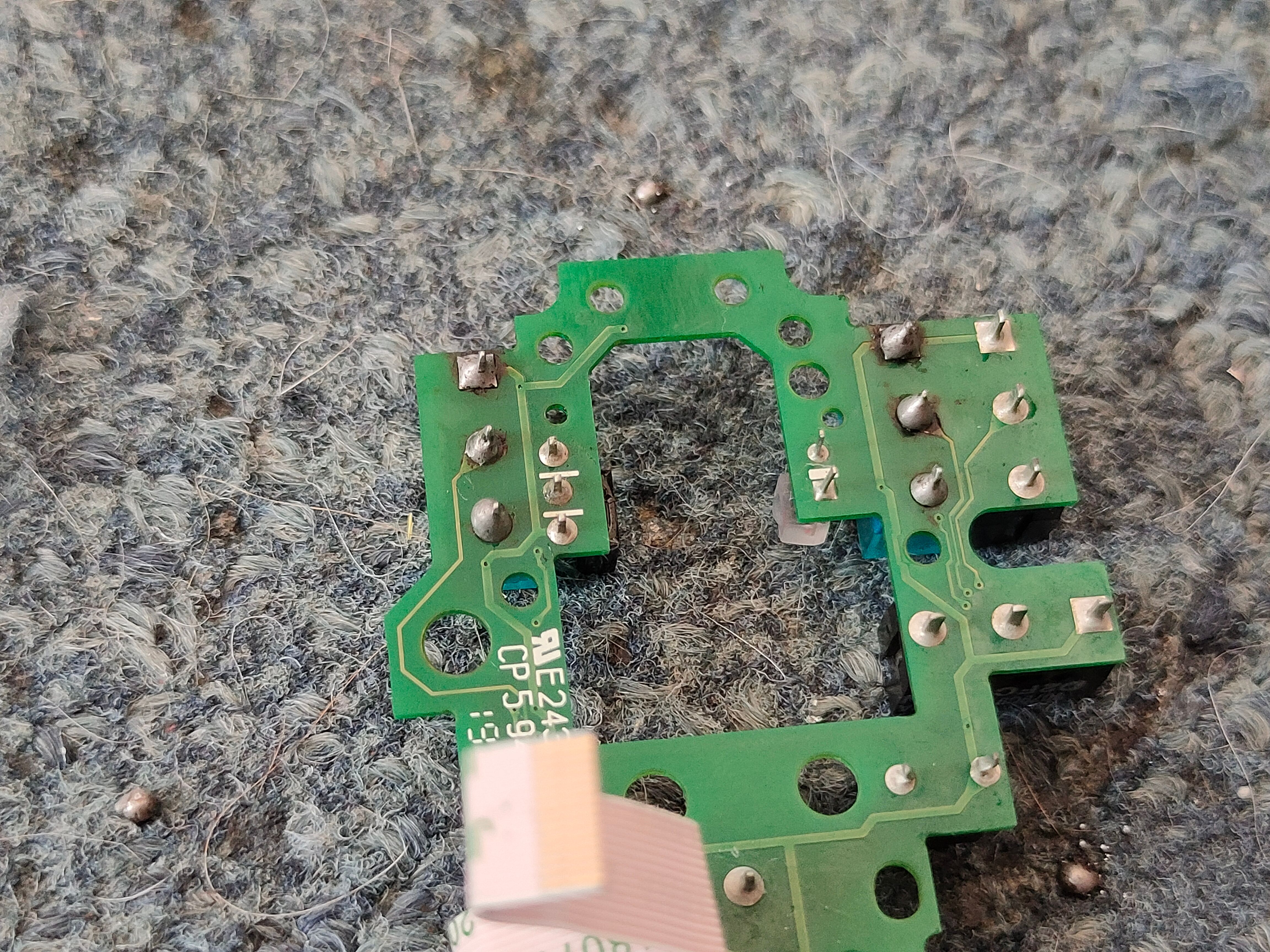 Poorly-done soldering job on the back of a G502 PCB.