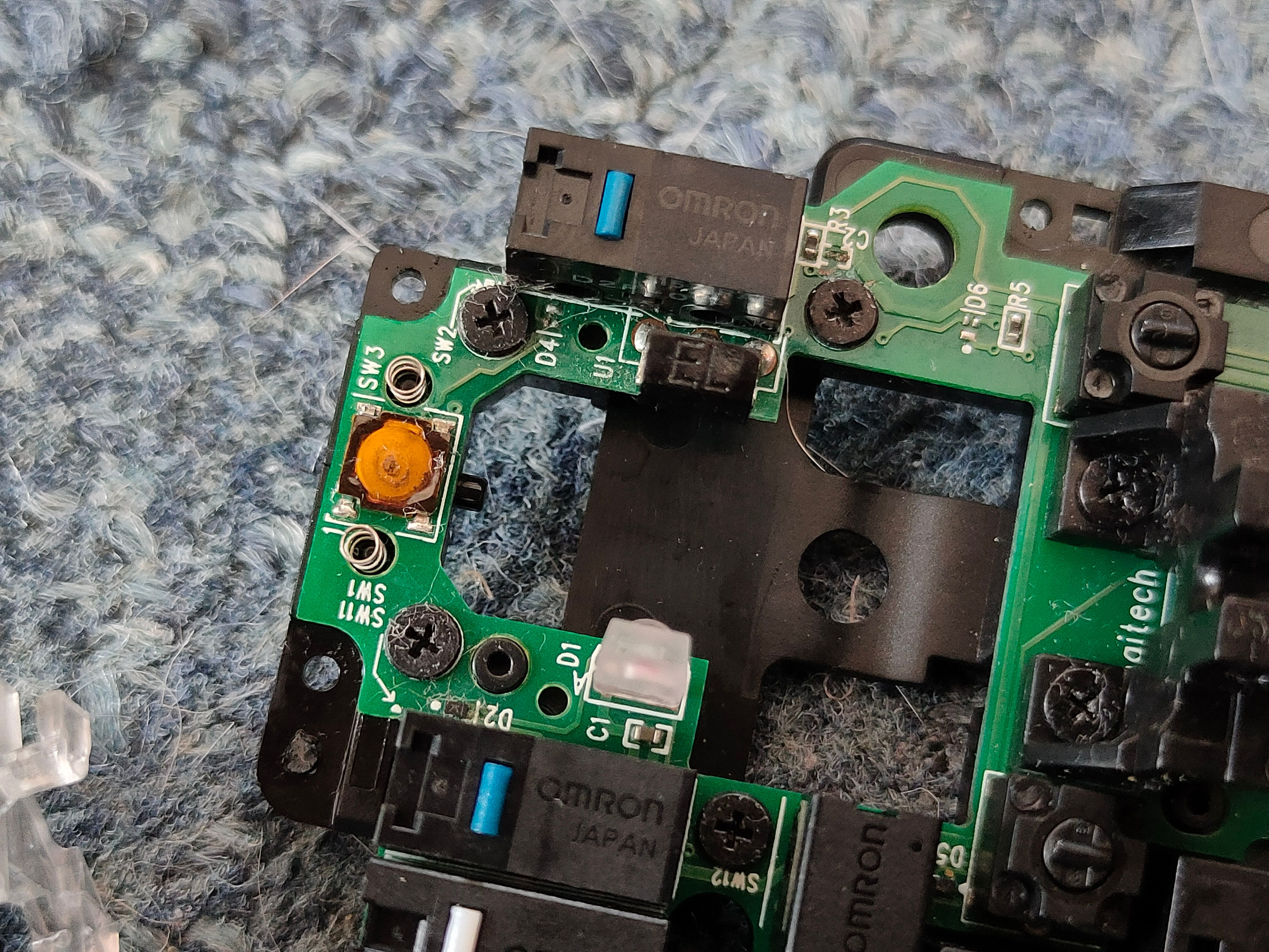 Japanese Omron switches on a Logitech G502 PCB with the plunger mod installed.