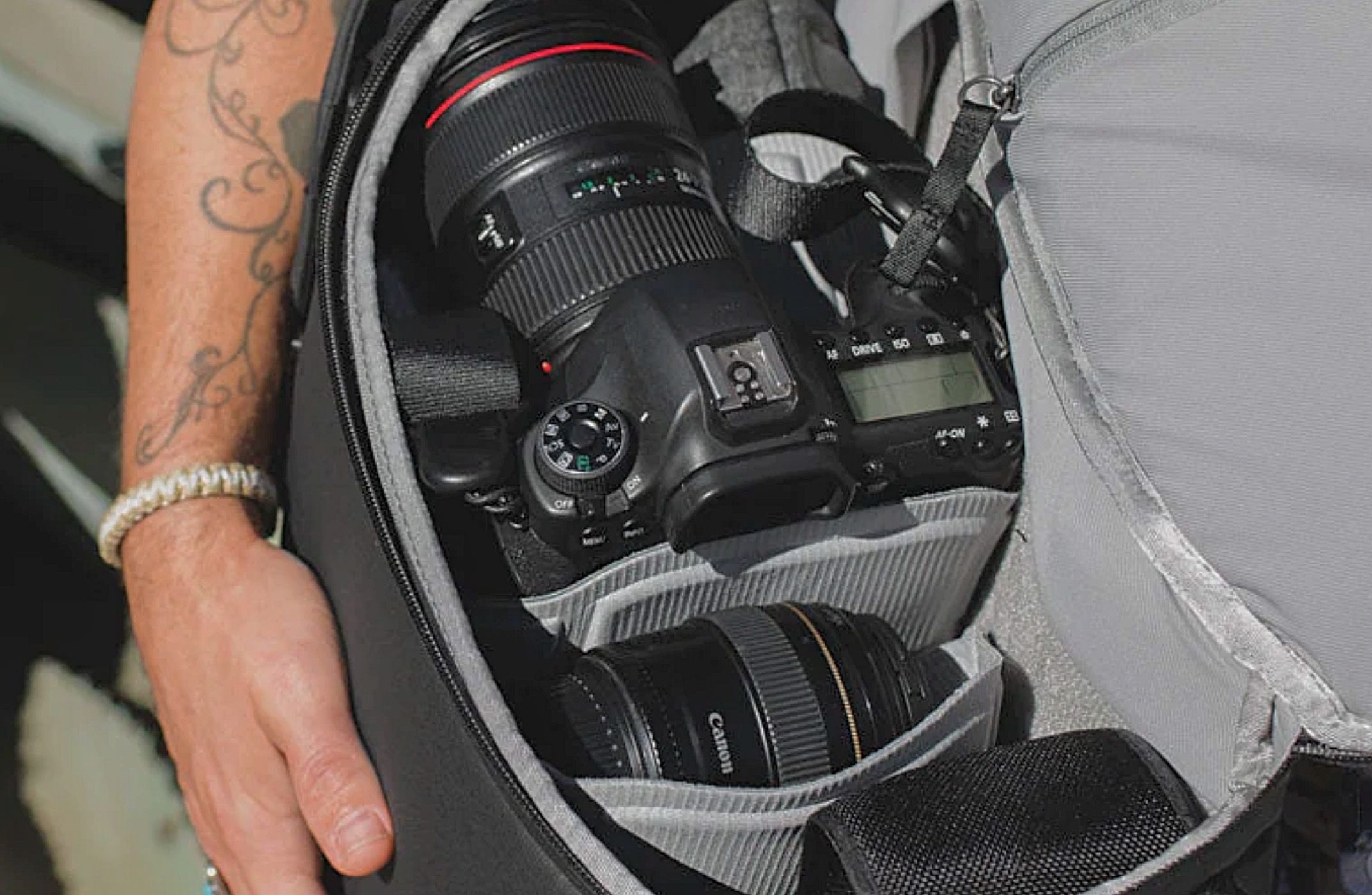 A man showing the contents of his Peak Design Everyday Backpack V2 20L.