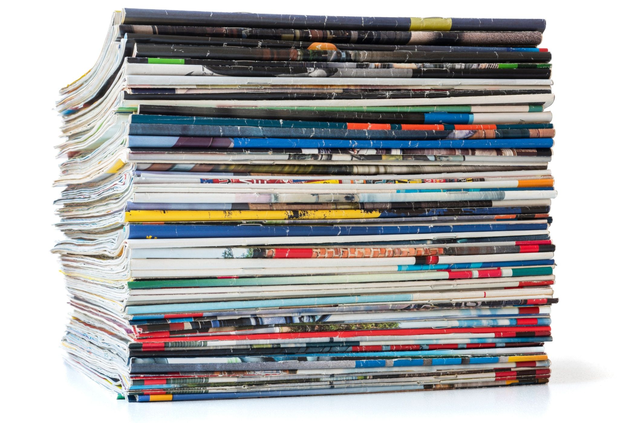 Pile of old paper magazines isolated on white background.