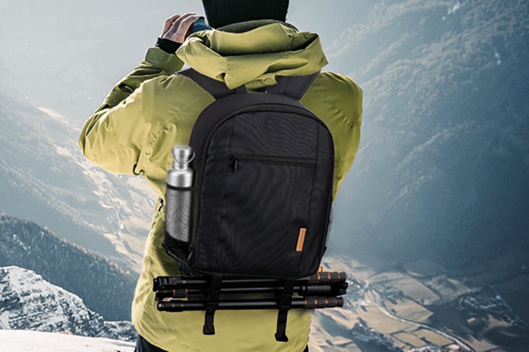 A man hiking in the mountains with a Tarion Camera Backpack TB-S on his back.