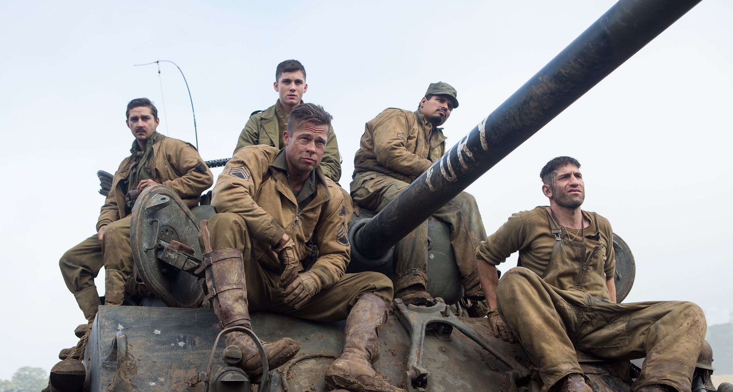 The tank crew from Fury sitting on their tank.