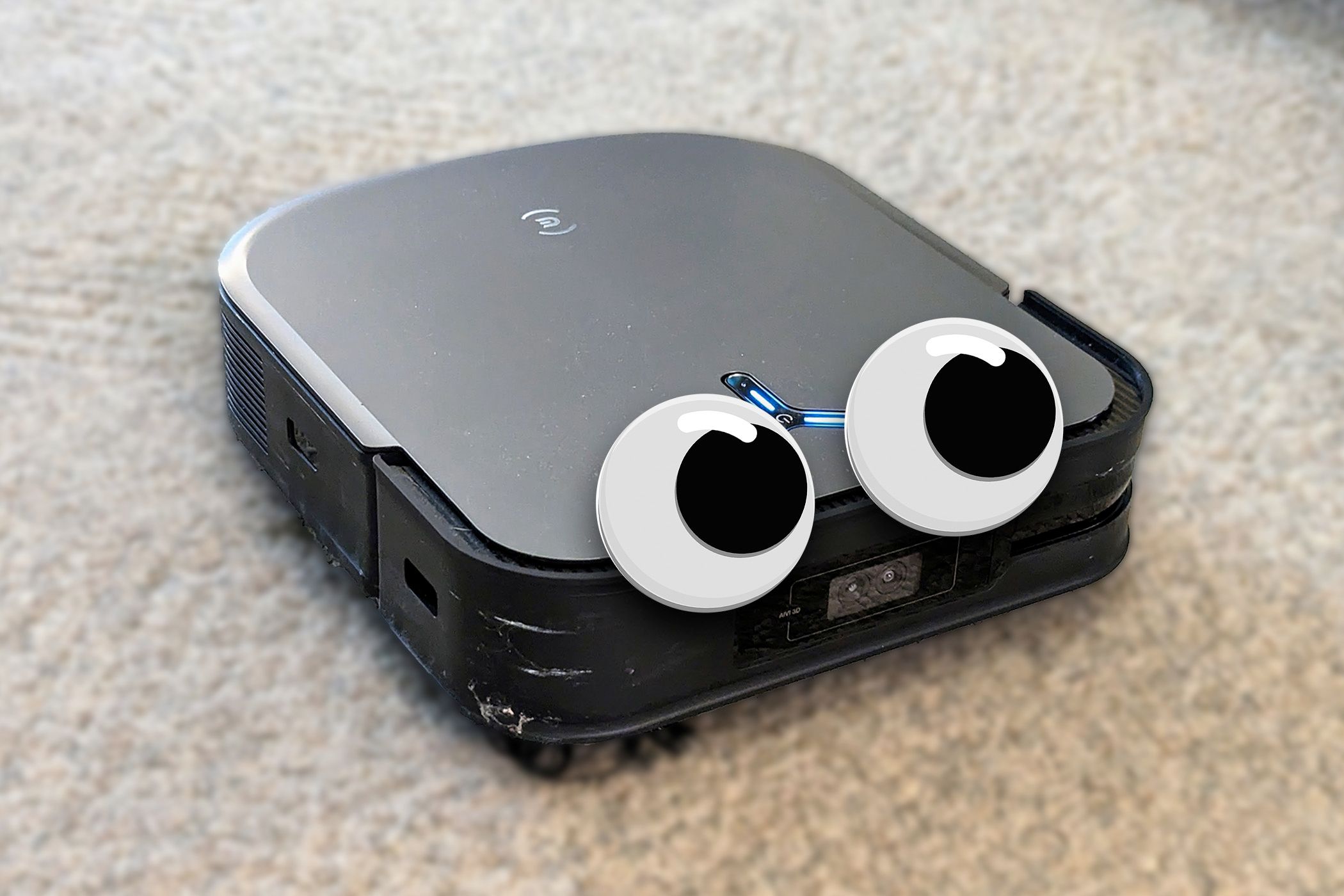 An Ecovacs robot vacuum with big googly eyes.