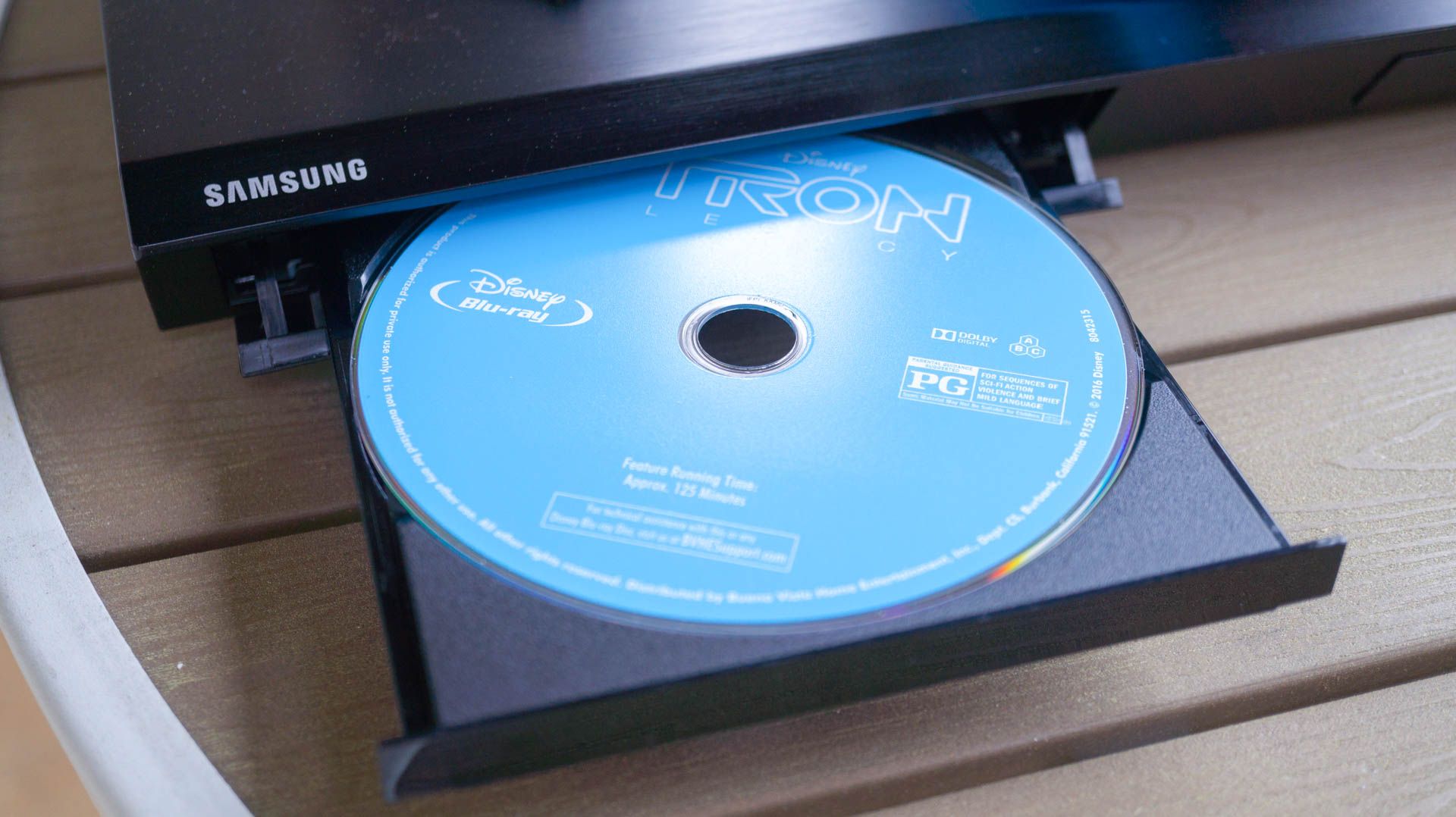 Blu-ray disc in Blu-ray player drive tray.