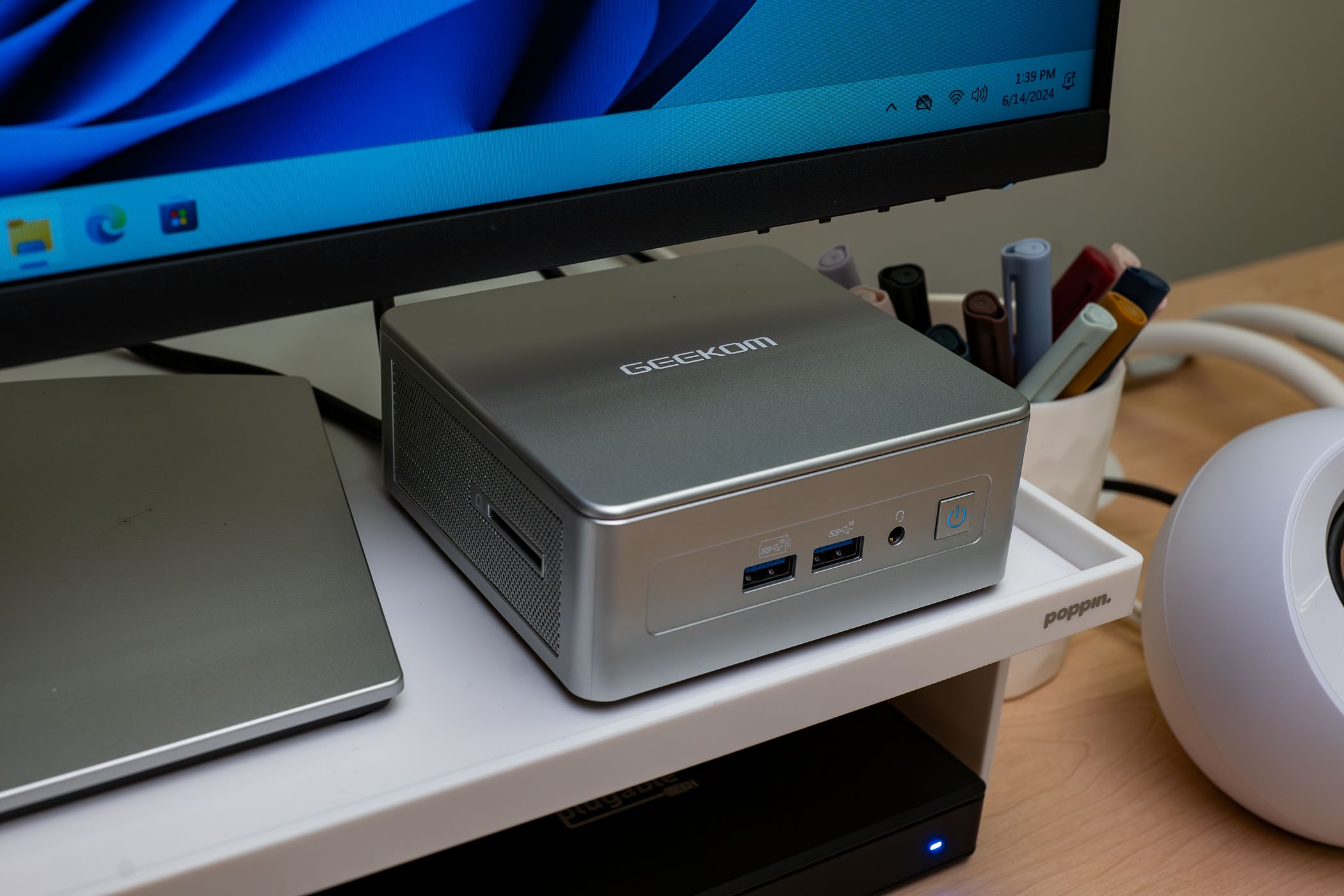 GEEKOM AE7 Mini PC connected to monitor, desktop organization