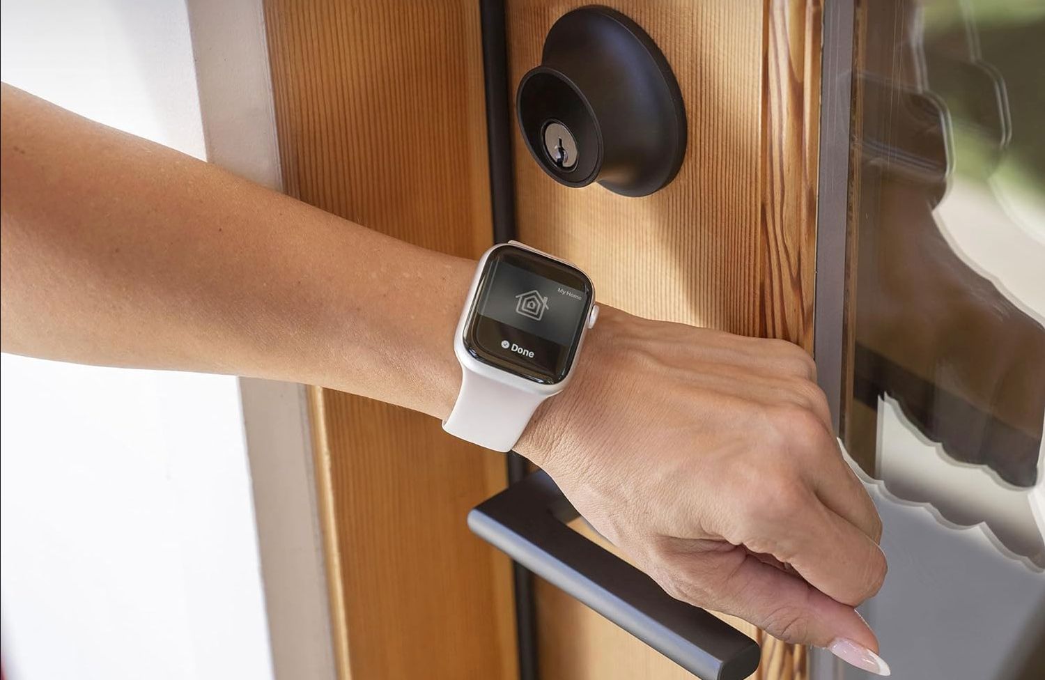 A woman using Apple Home Key on Apple Watch.