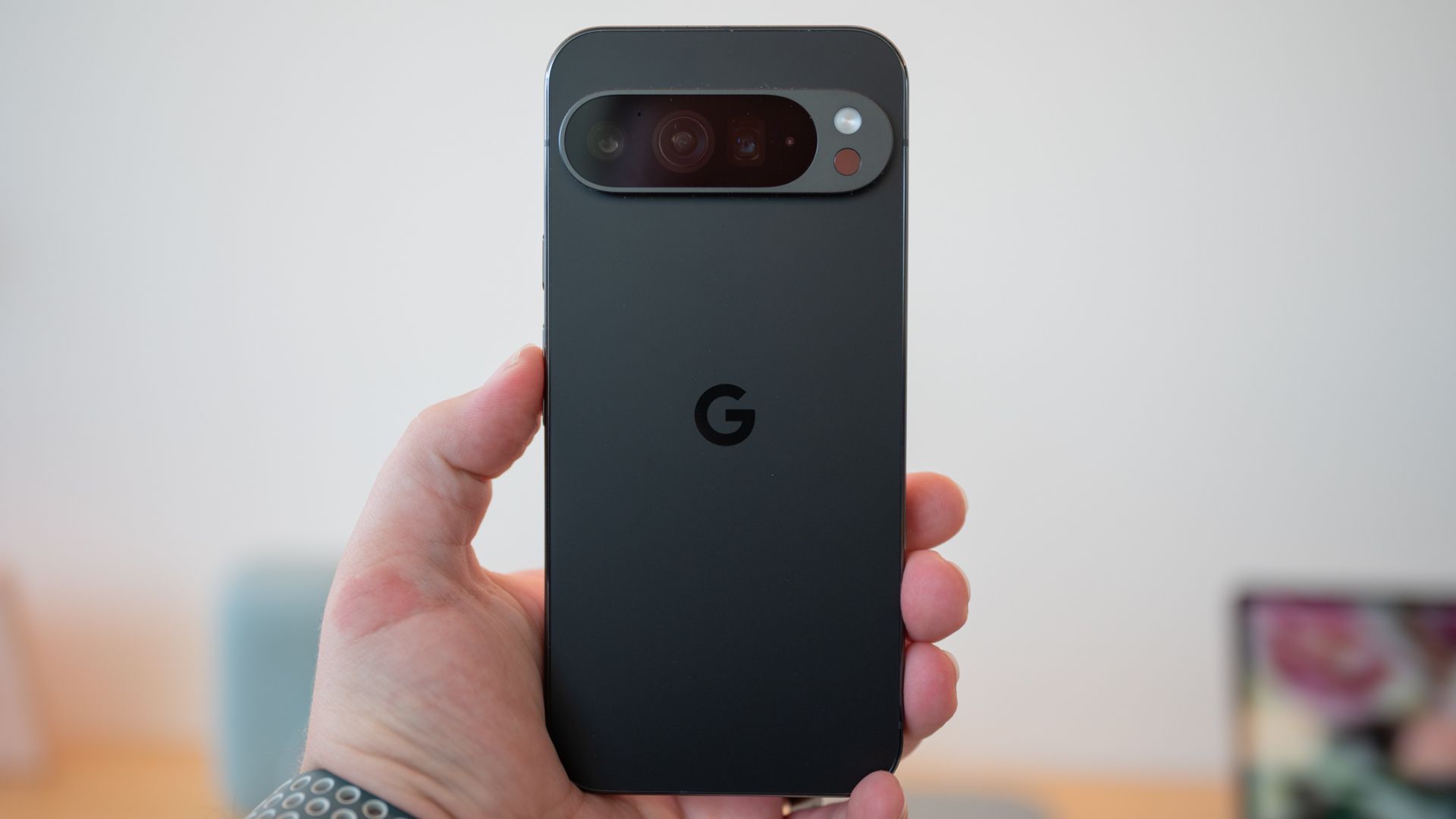 A person holds the Google Pixel 9 Pro smartphone. 