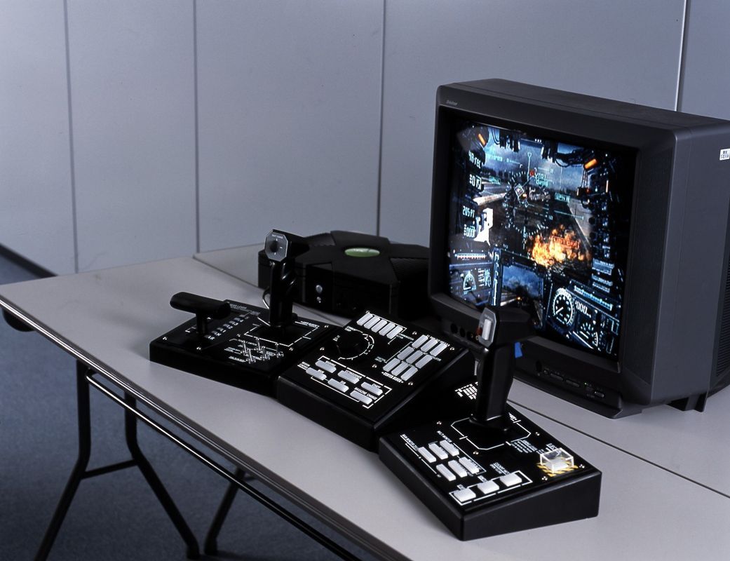 A prototype version of the Steel Battalion controller next to an Xbox and monitor.