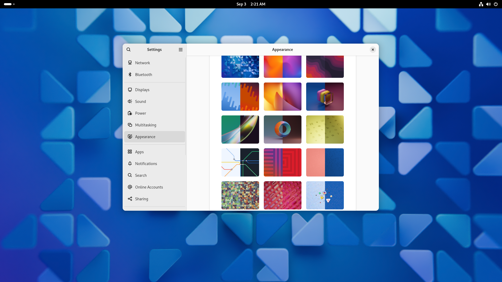 The GNOME 47 default desktop with the wallpaper selector open.