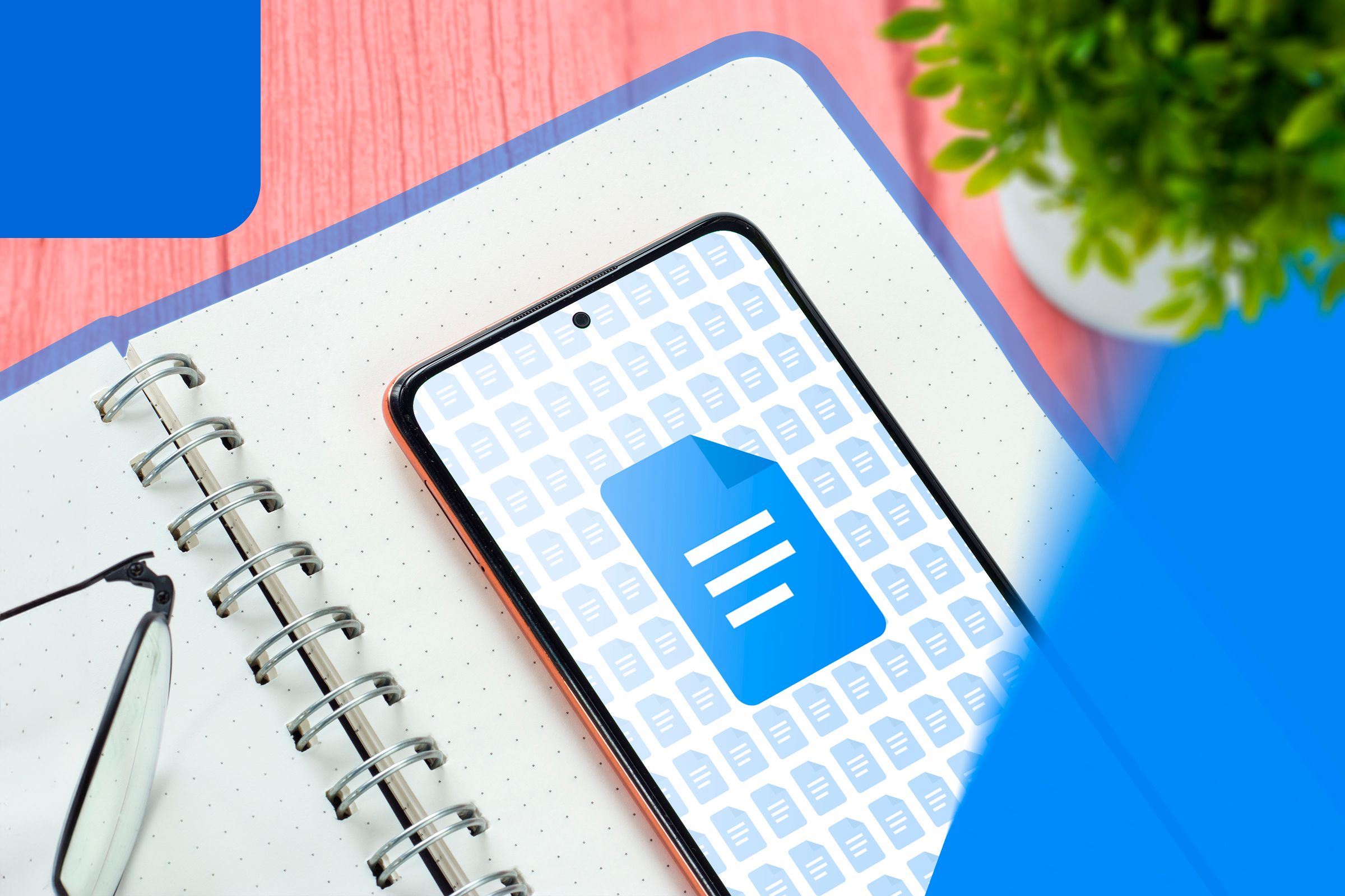 A phone above a notebook with Google Docs icon.