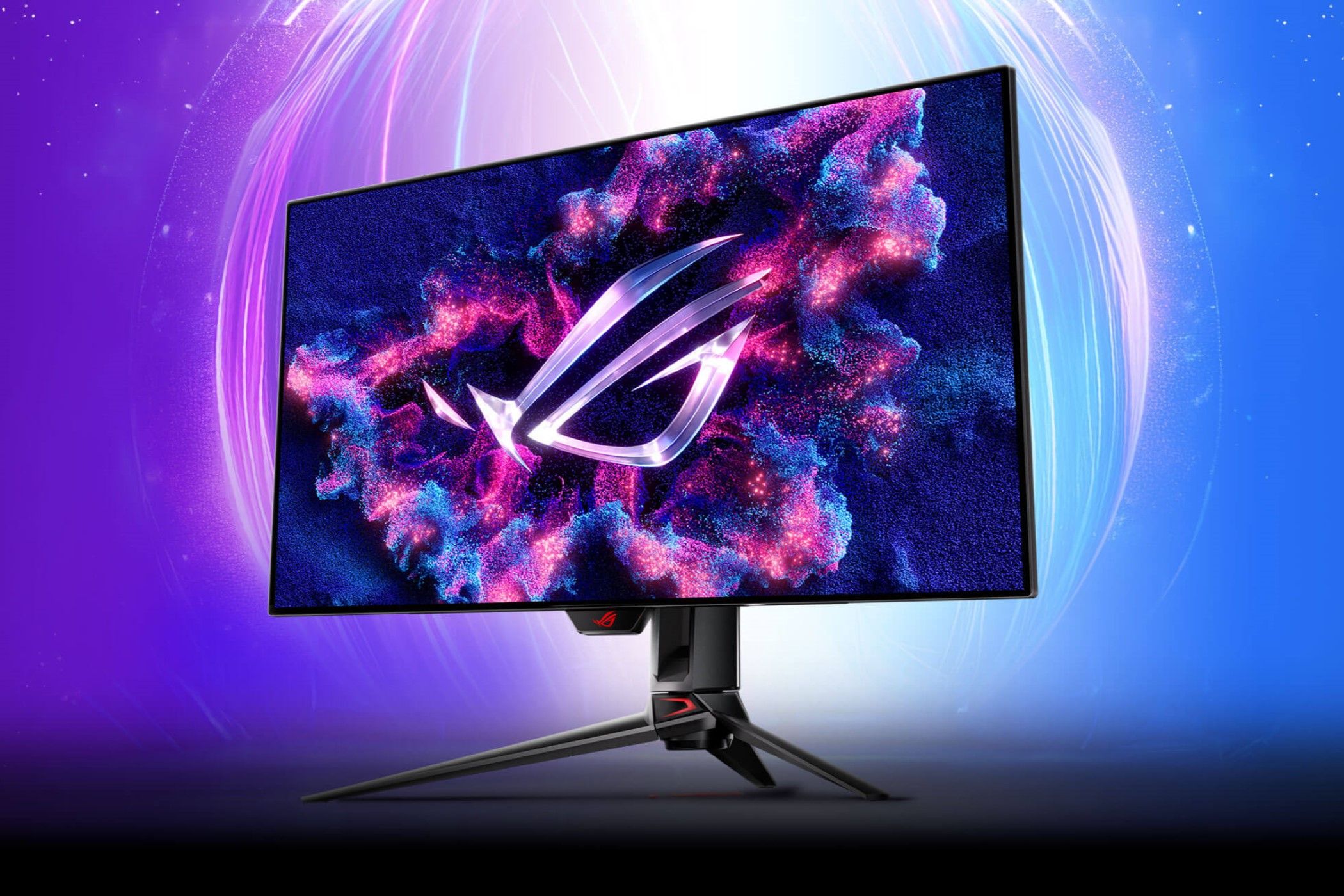 ASUS ROG Swift OLED PG32UCDP against a purple and blue background. 