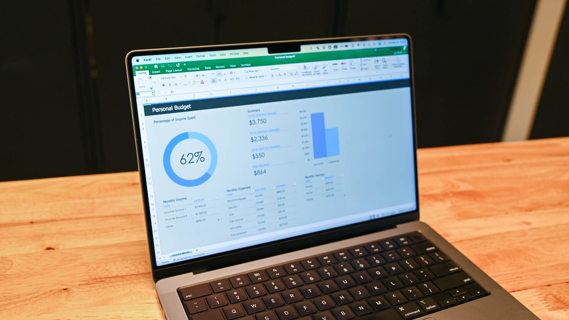 A personal budget spreadsheet seen on a laptop.