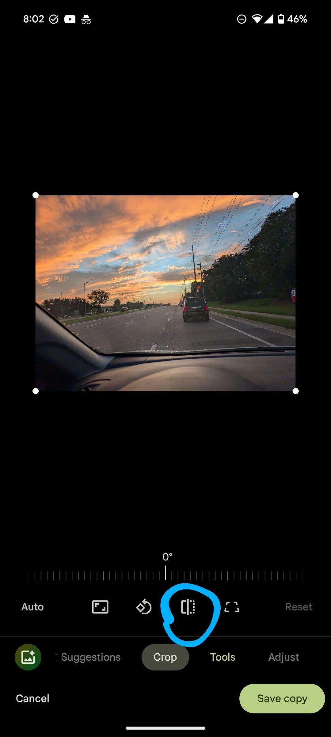 Google photos image of car on the road from the dashboard, over editing options. The Flip image option is circled.