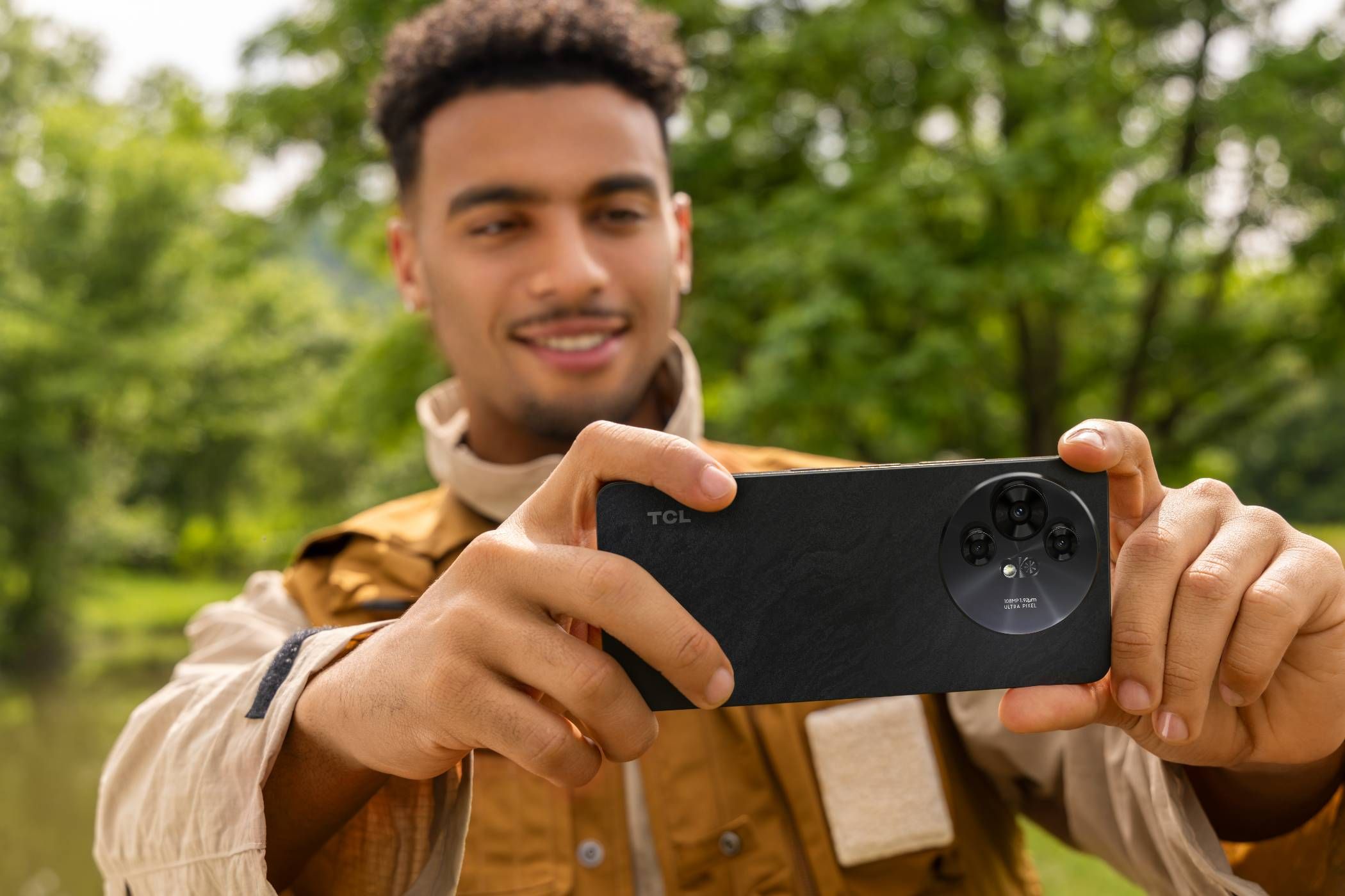 The TCL NXTPAPER being held and used so the rear camera is taking a picture