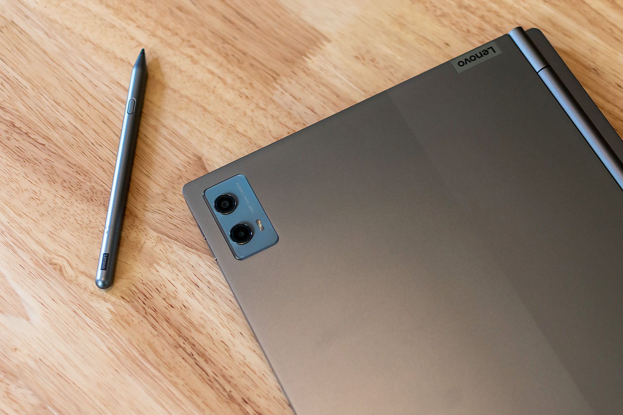 The Lenovo ThinkBook Plus Gen 5 Hybrid closed on a table next to its stylus.