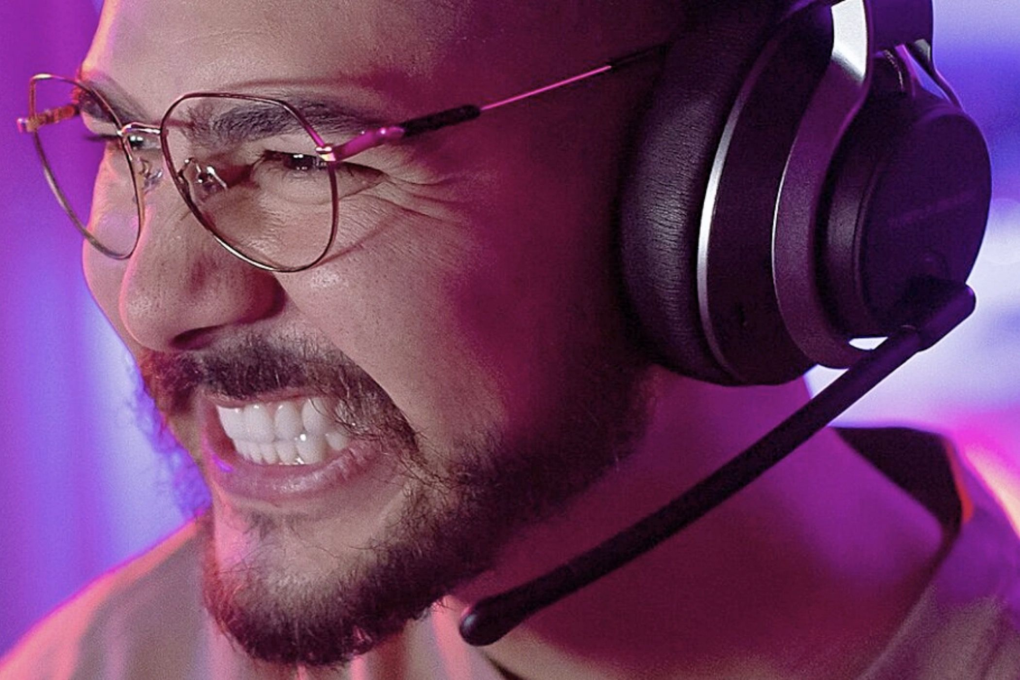 A bearded man wearing a Turtle Beach Stealth Pro headset.