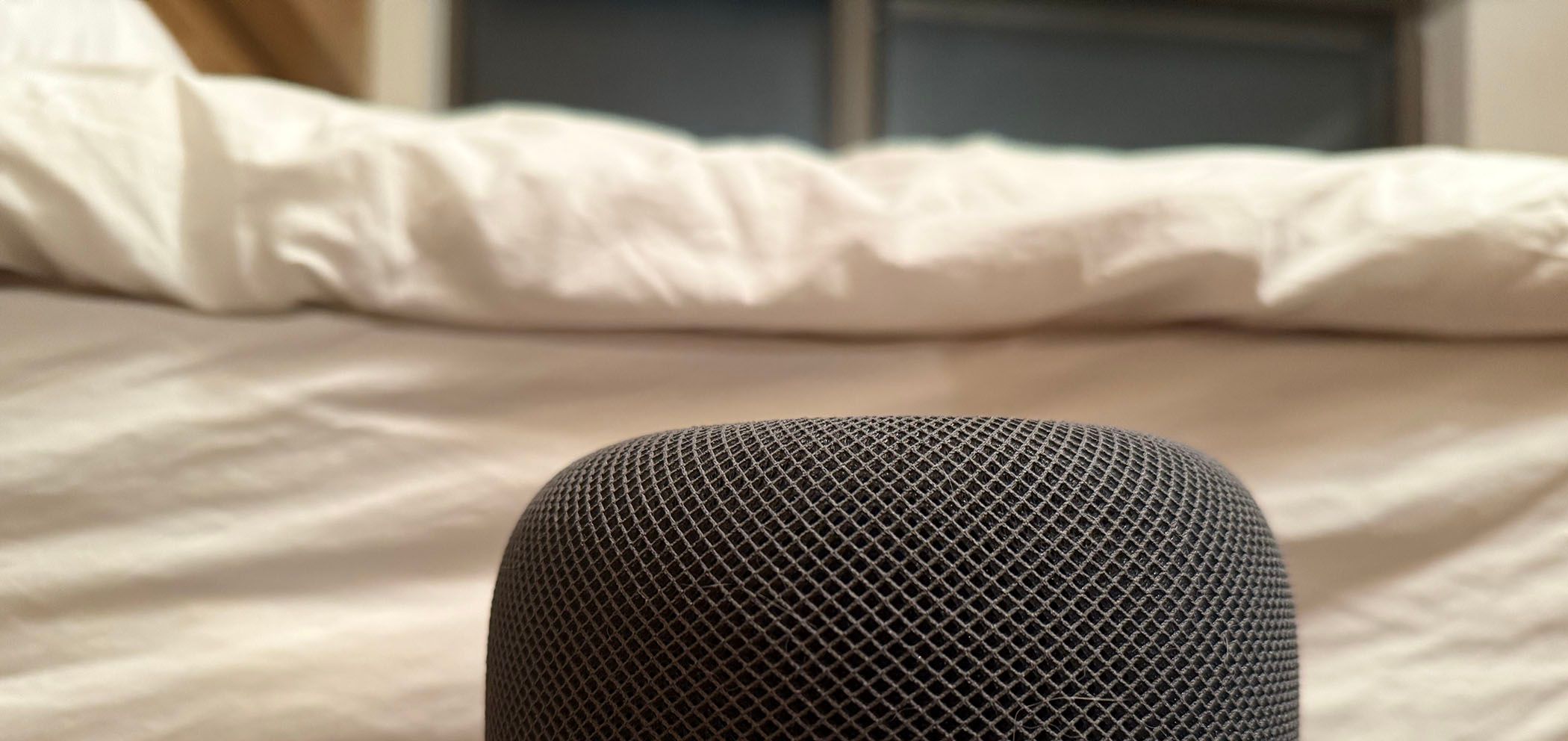 A smart speaker in a bedroom.