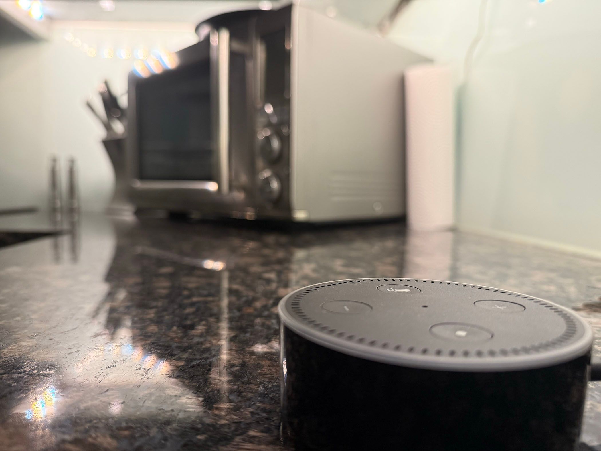 An Amazon Echo smart speaker in a kitchen.