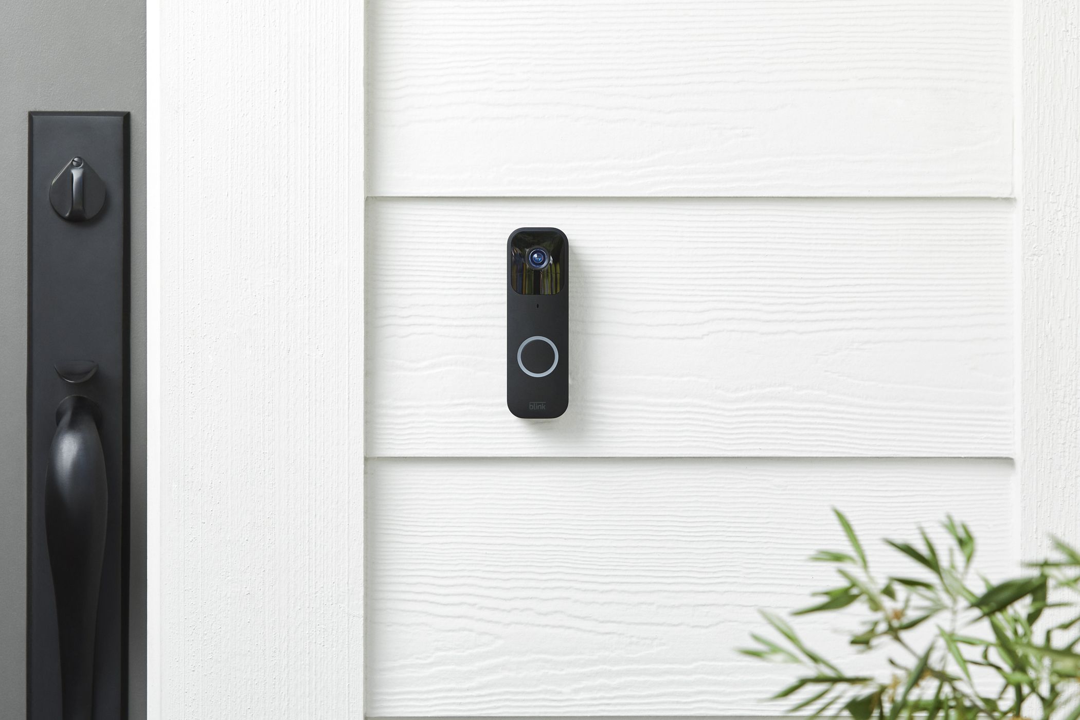 A blink video doorbell mounted near a front door. 