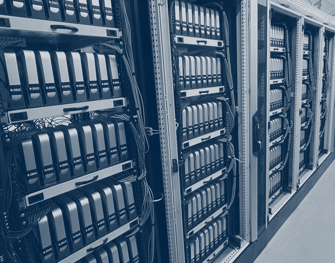 A photo of dozens of Mac Minis organized in server racks.