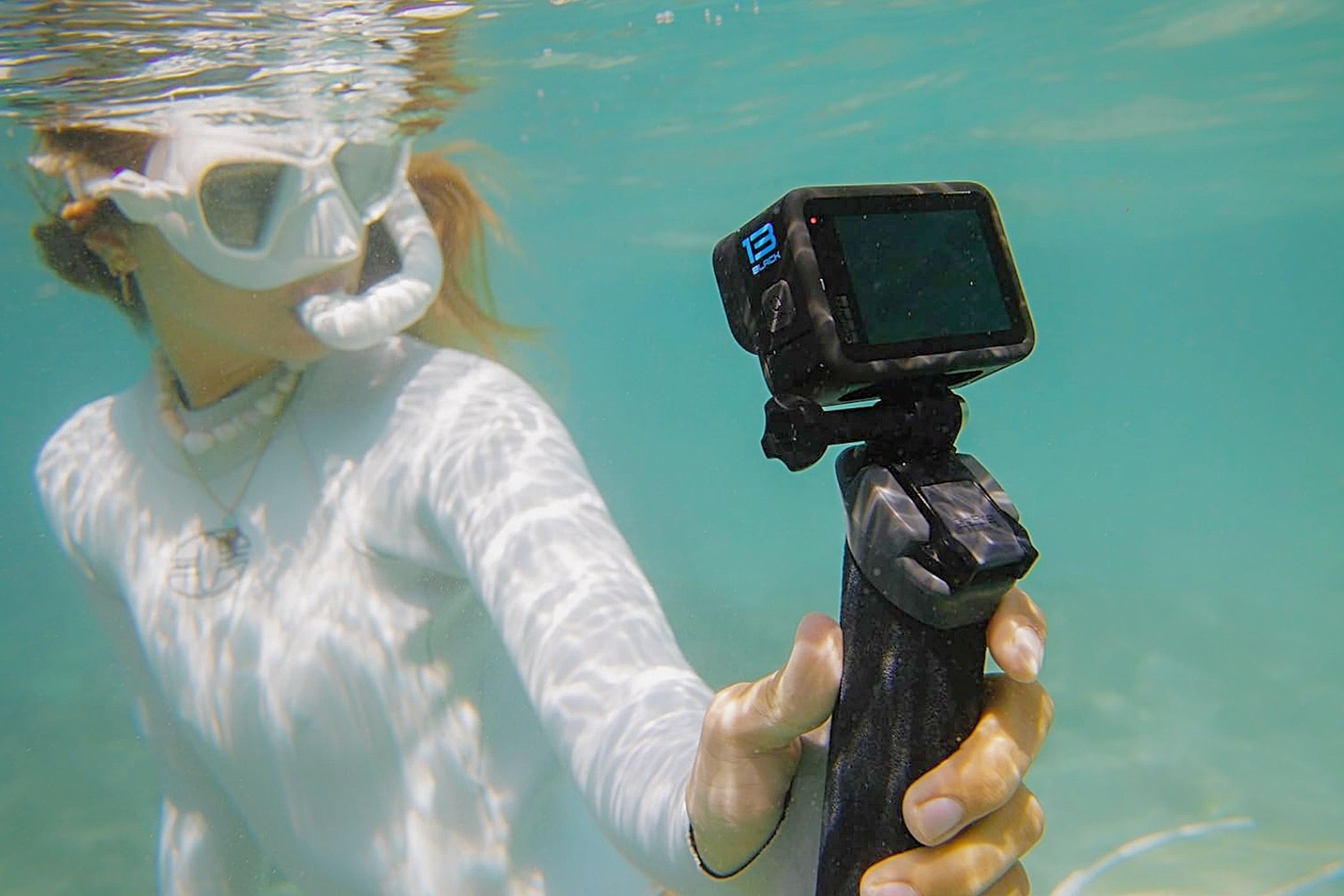 A woman underwater with the GoPro Hero13 Black.