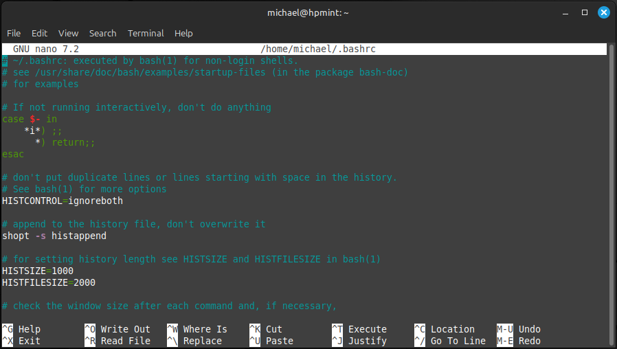 The beginning of the .bashrc file displayed in the nano text editor