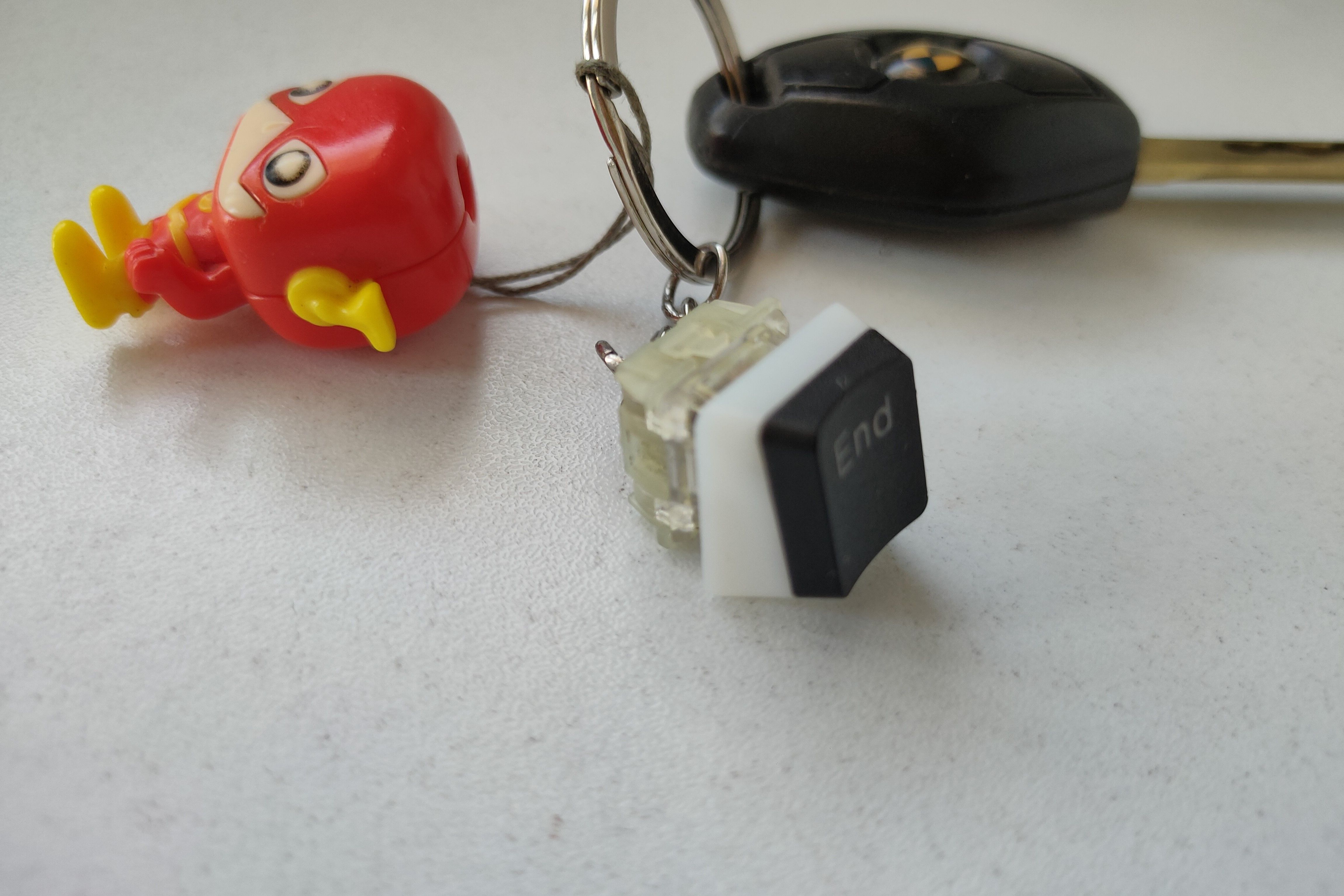 An old mechanical keyboard switch repurposed into a keychain charm.