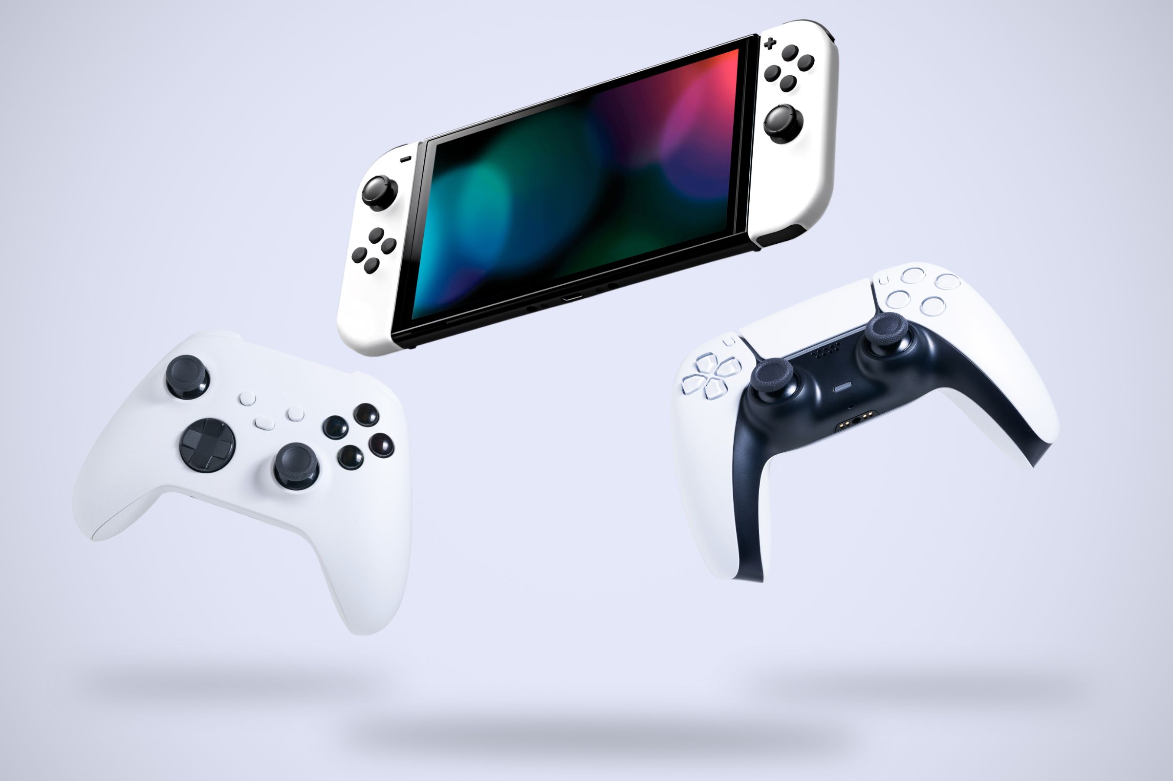 PlayStation controller, Xbox controller, and Nintendo Switch console in the air.