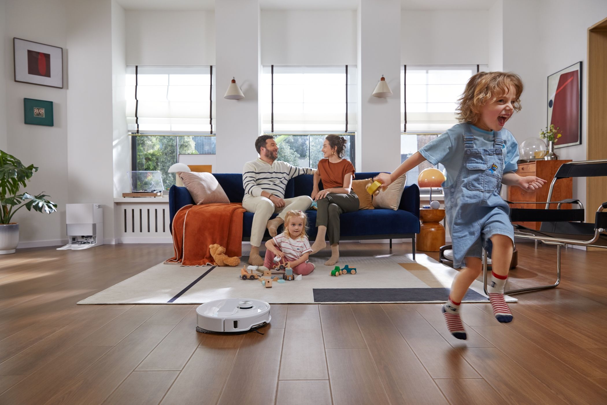 A Family Enjoying While Roborock Qrevo Master Cleans the Floor