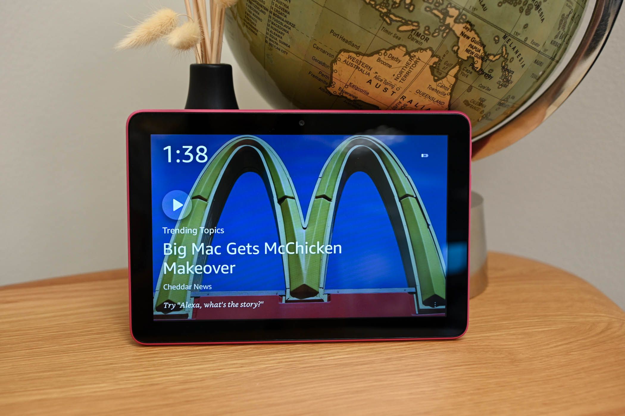 Show Mode Amazon Fire HD 8. Fire HD 8 sits on a wood table with a globe behind it. 