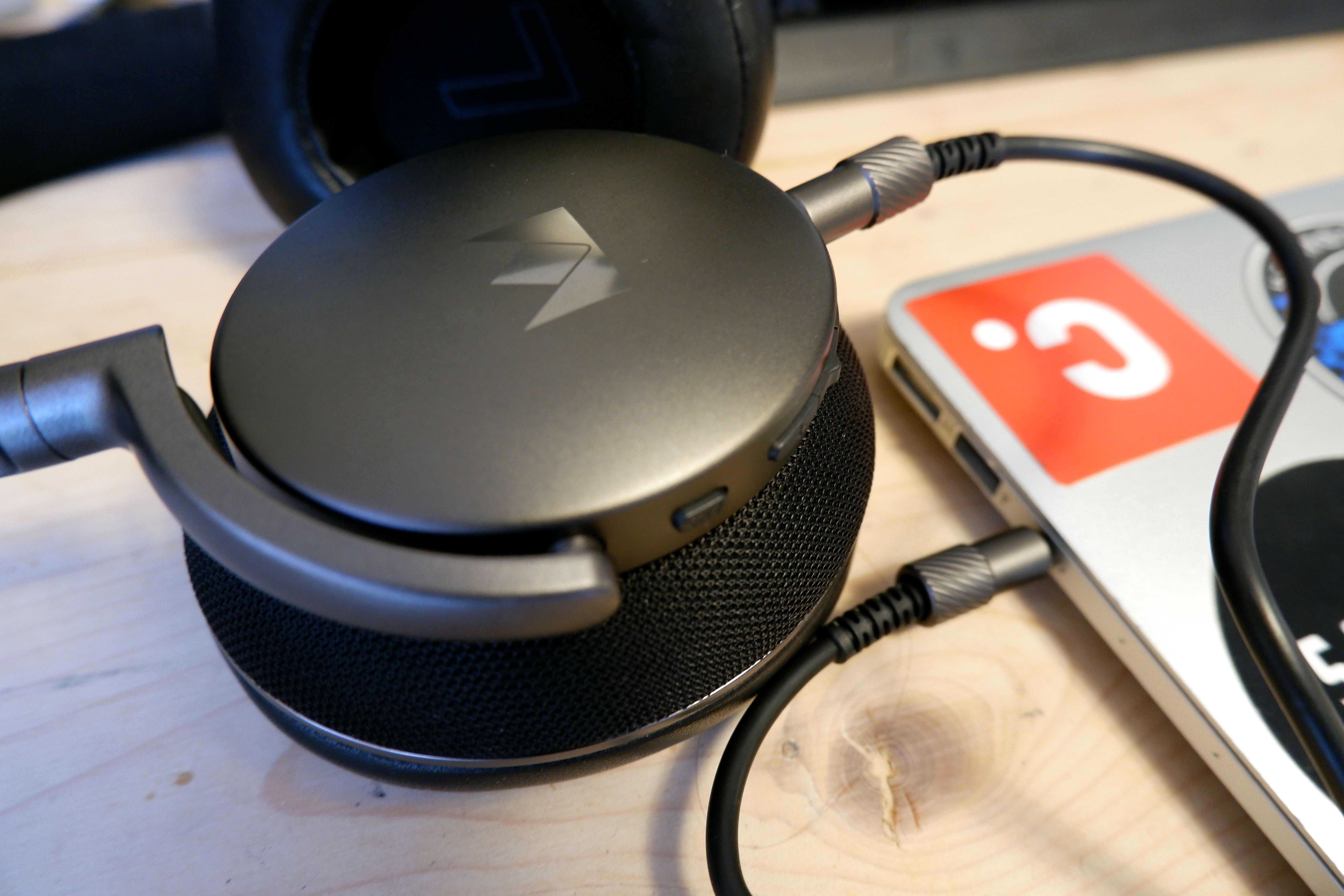 A pair of Noble Fokus Apollo headphones plugged into a Macbook Air