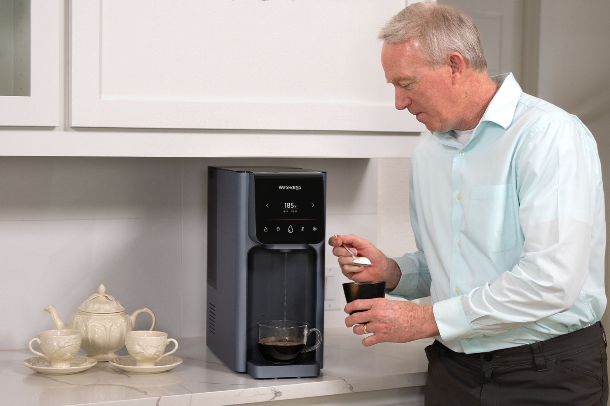 A Man Dispensing Hot Water for Coffee From the Waterdrop A1