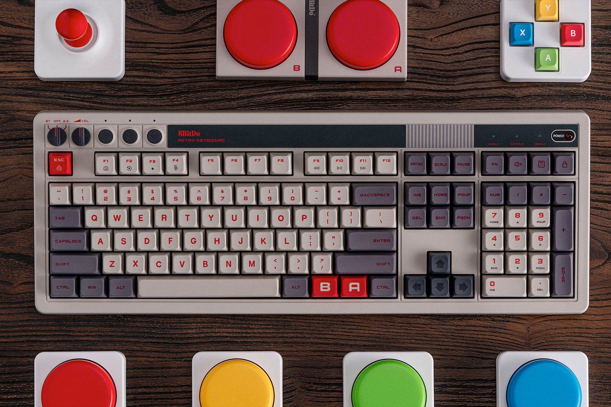 The 8BitDo Retro 108 Mechanical Keyboard on a desk with some accessories.