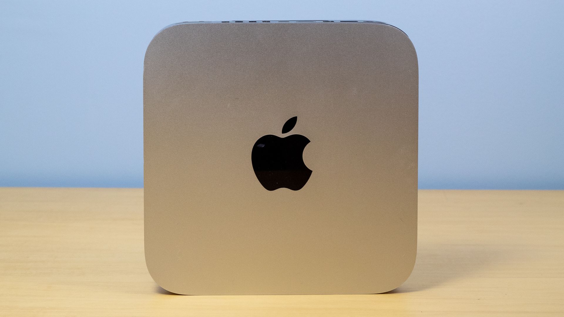 A Mac Mini propped up on a table.