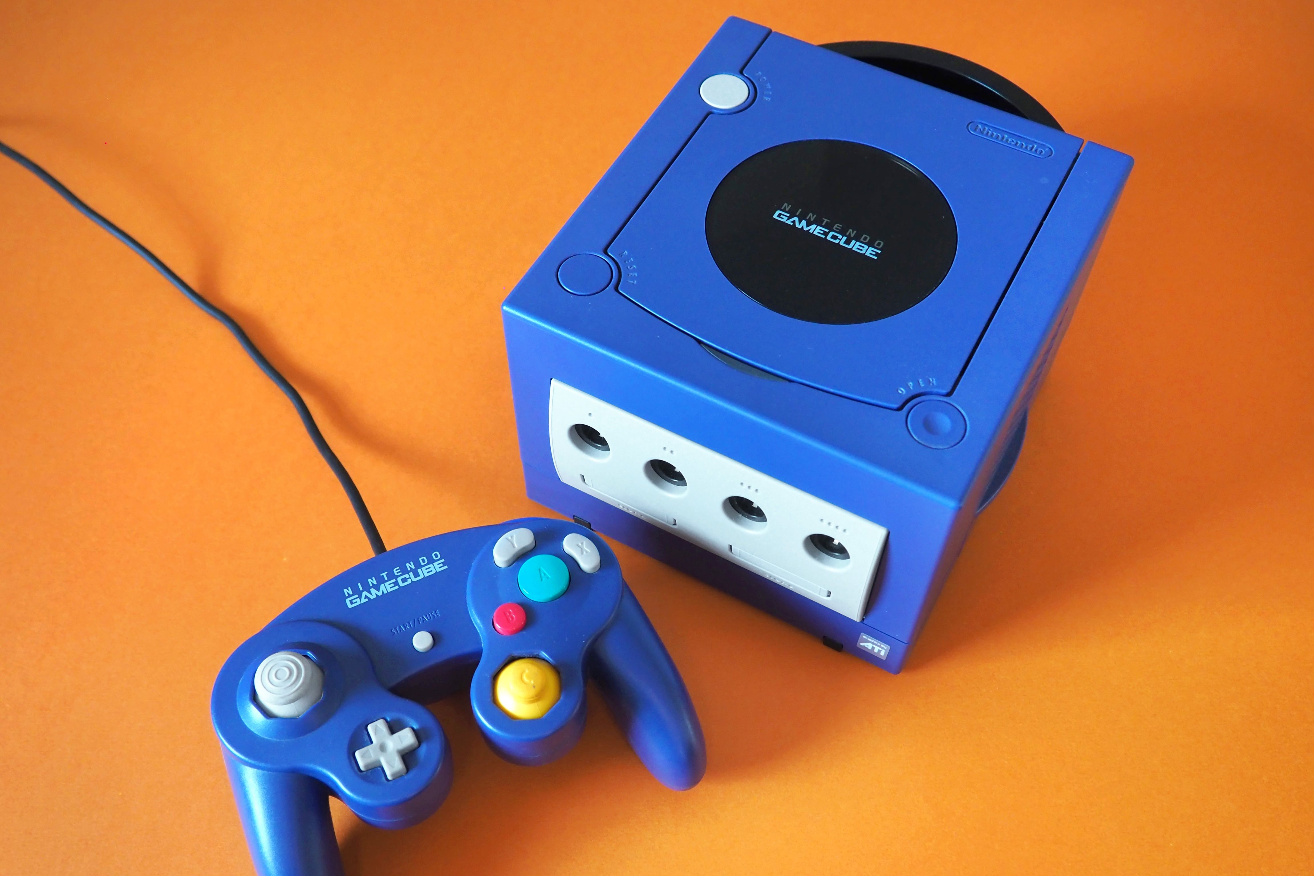 A blue Nintendo GameCube on an orange background.