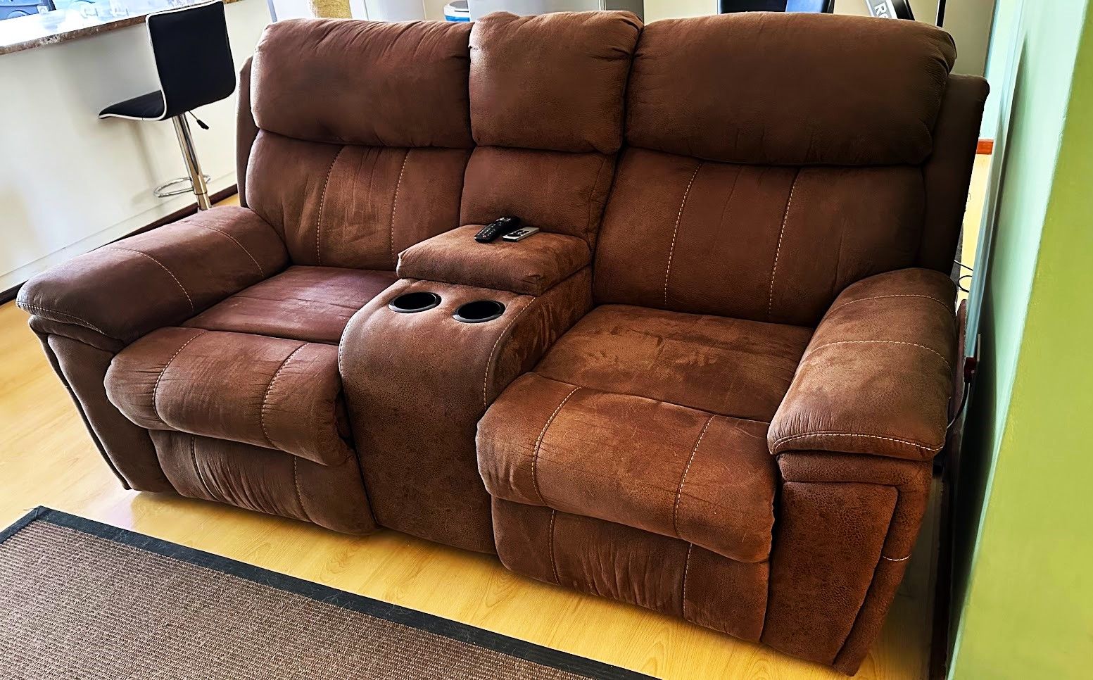 Brown double recliner with center console.