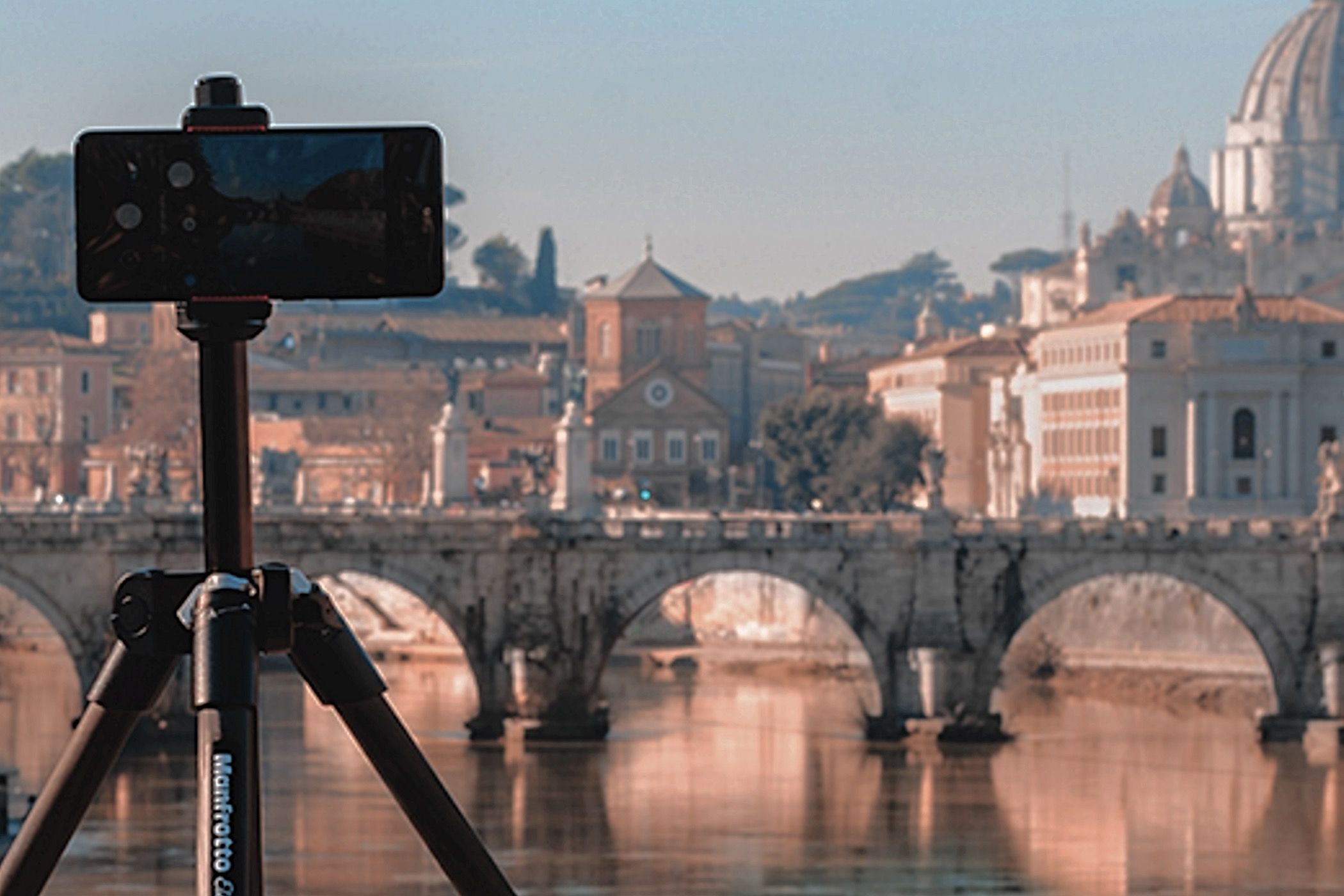 A smartphone mounted on a Manfrotto Element MII 4-Section Aluminum Tripod.