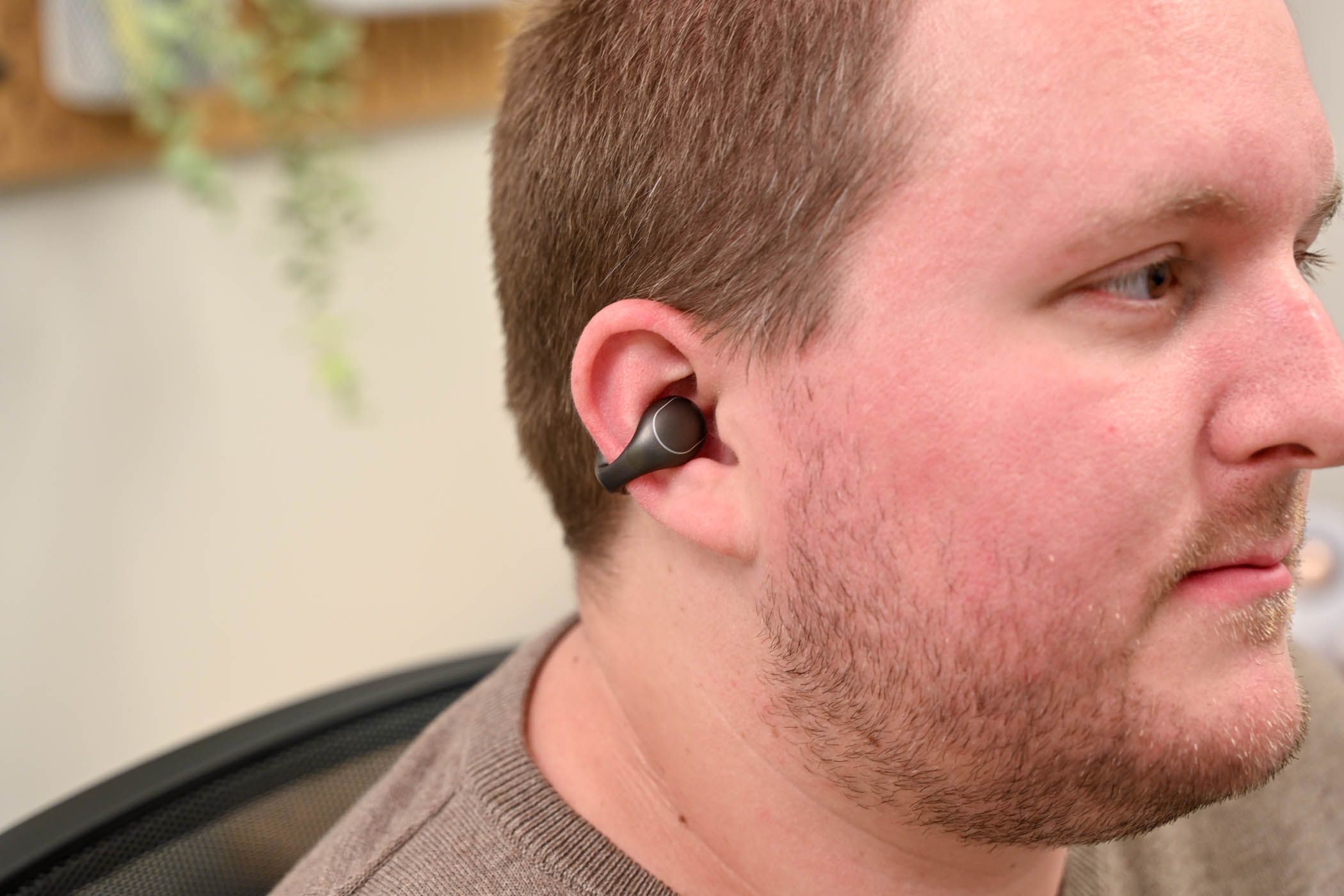 Person wearing a Soundcore C40i earbud.