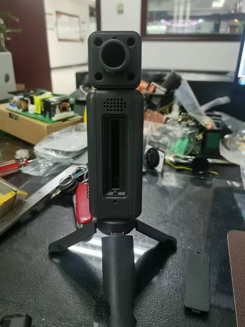 PineCam Tripod standing on a black surface