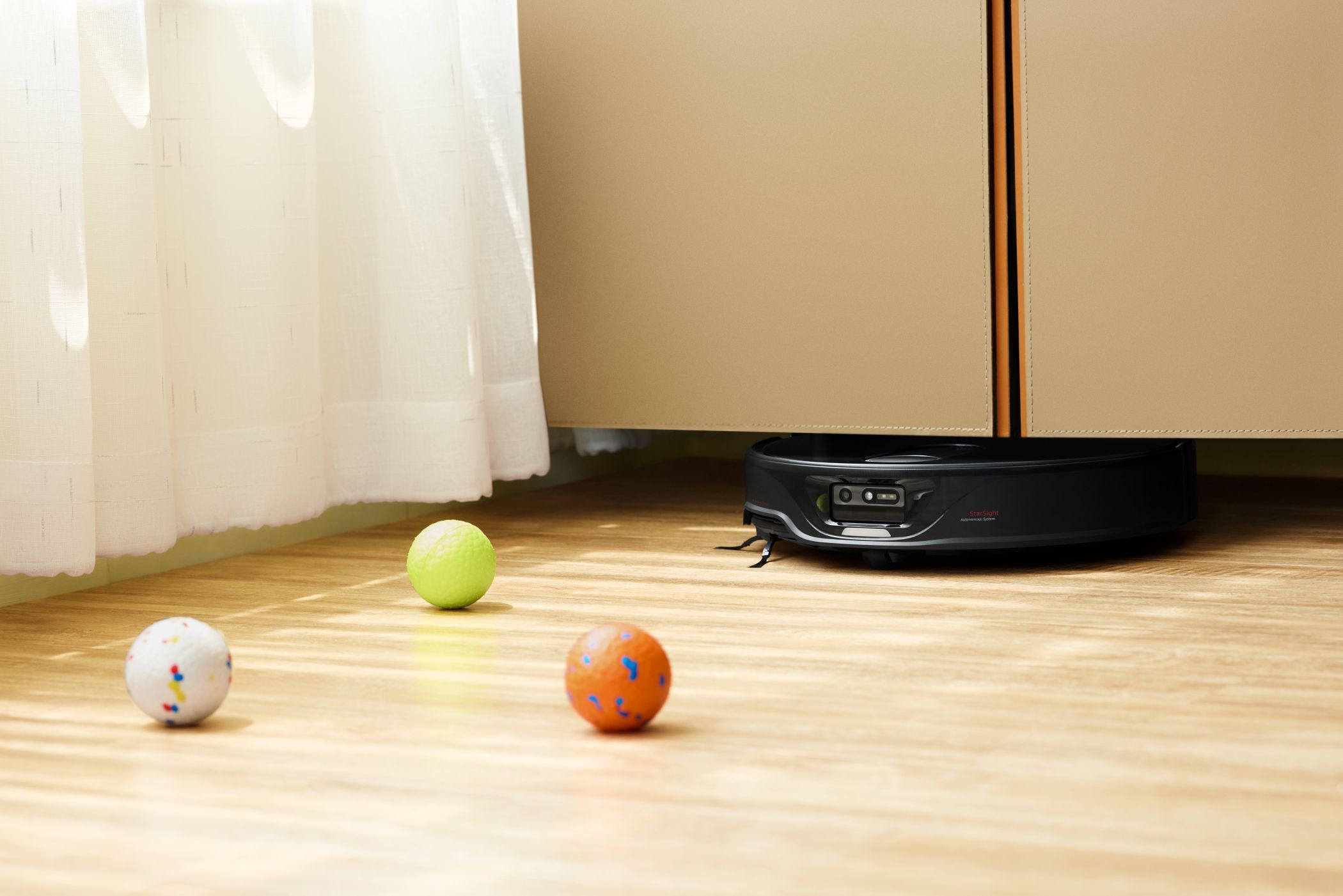 Roborock Qrevo Slim Cleaning Under a Storage Cabinet