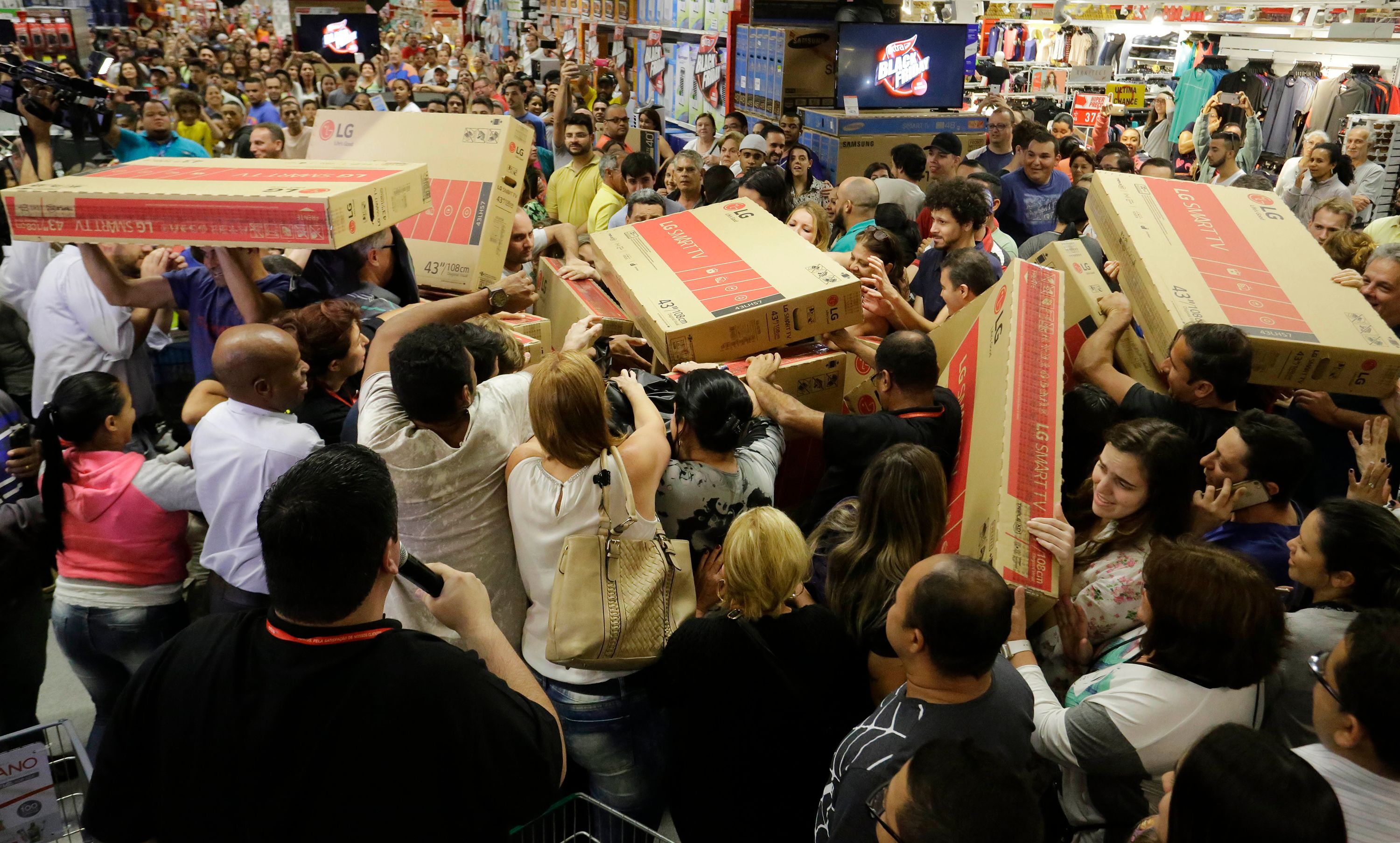 Shoppers rush to buy televisions during a Black Friday sale.