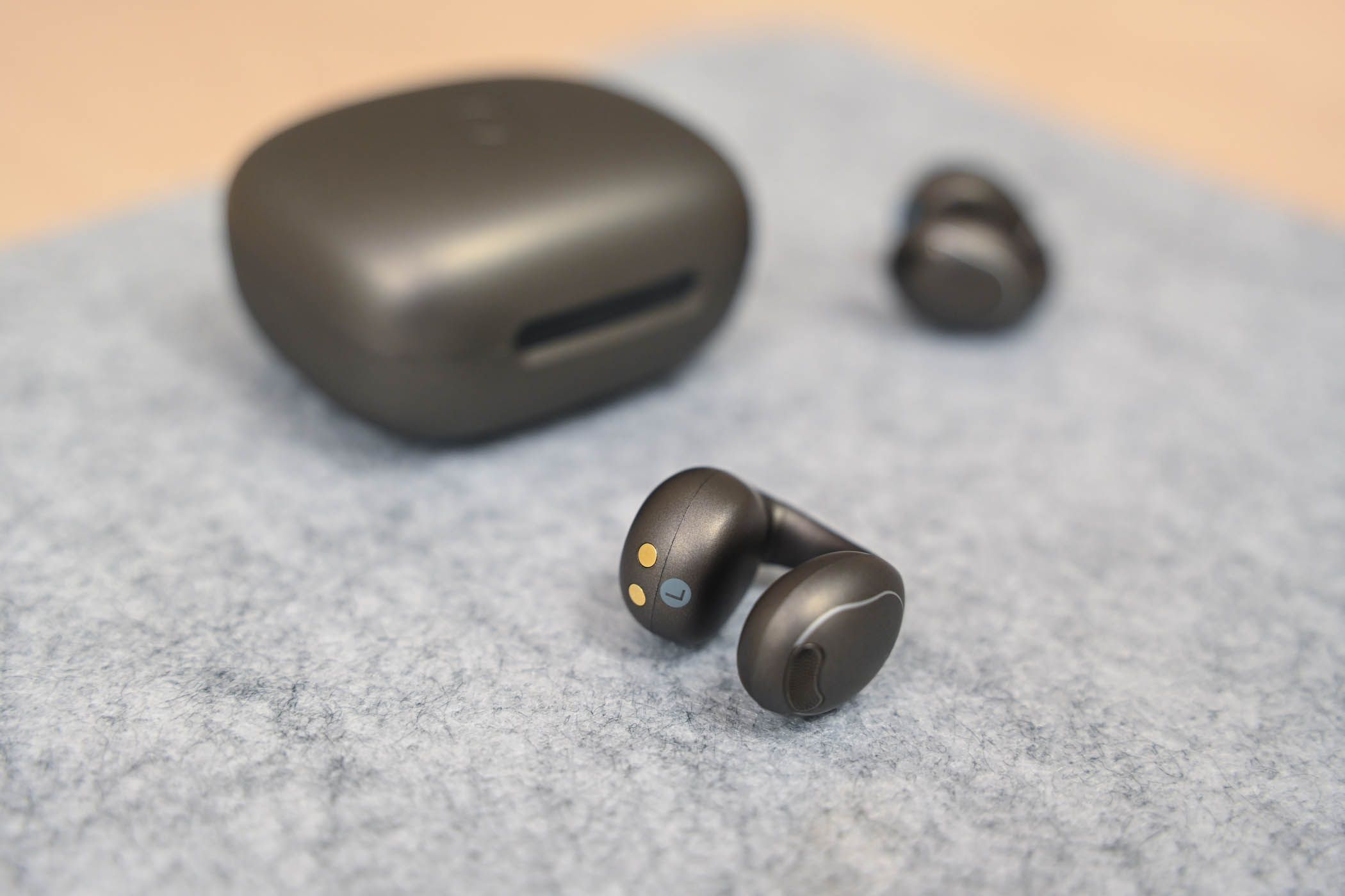 Soundcore C40i earbuds near their case.