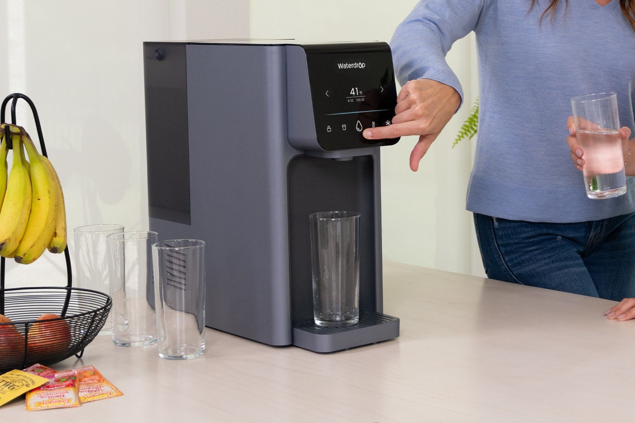 A Woman Using Smart Screen of Waterdrop A1 to Dispense Water