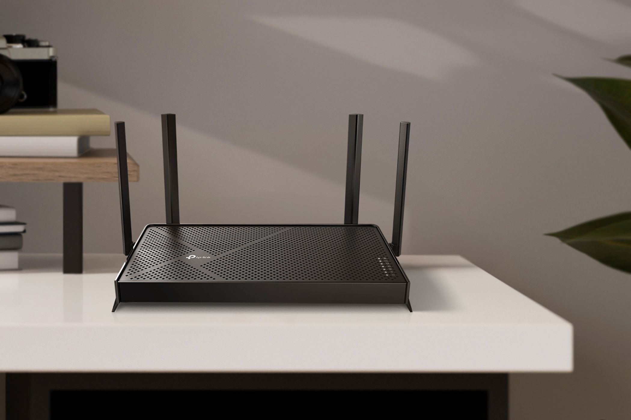 TP-Link Archer BE3600 Wi-Fi 7 router on a white workdesk.