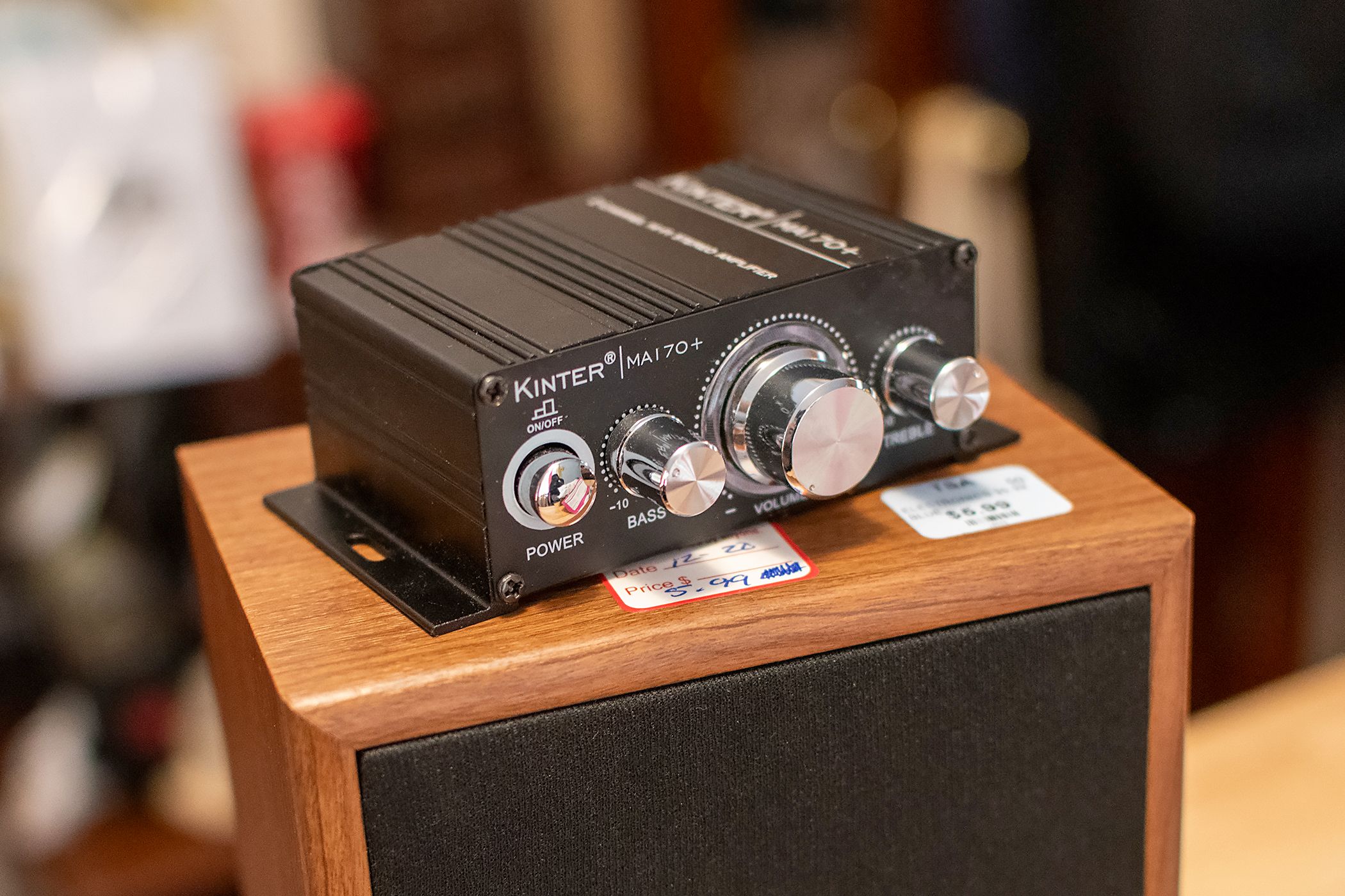 The Kinter amplifier sitting on top of a Technics speaker.