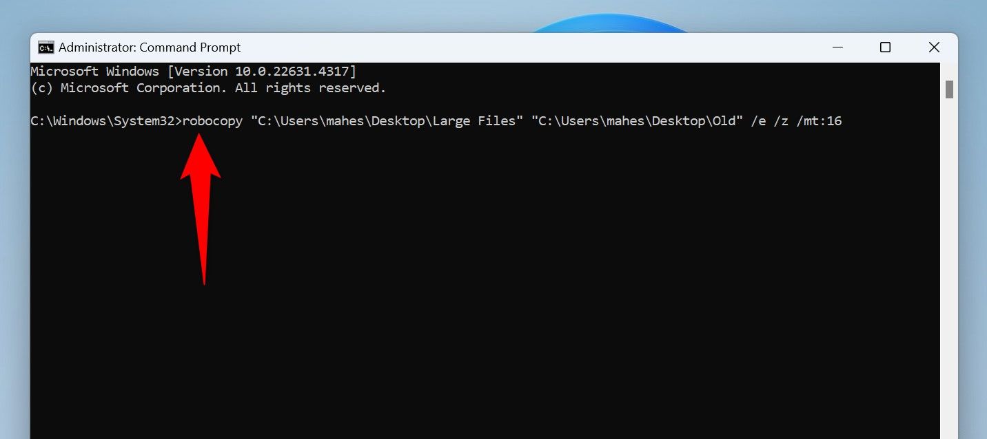 The command to copy files using Robocopy typed in Command Prompt.