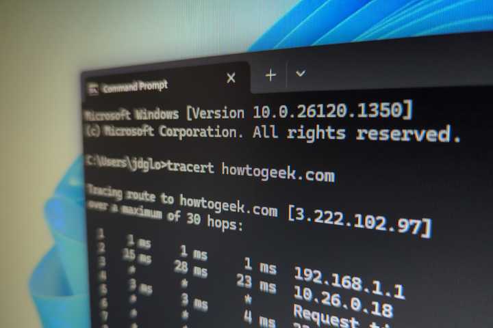 Closeup of a computer monitor with a command prompt open and the tracert command being used.