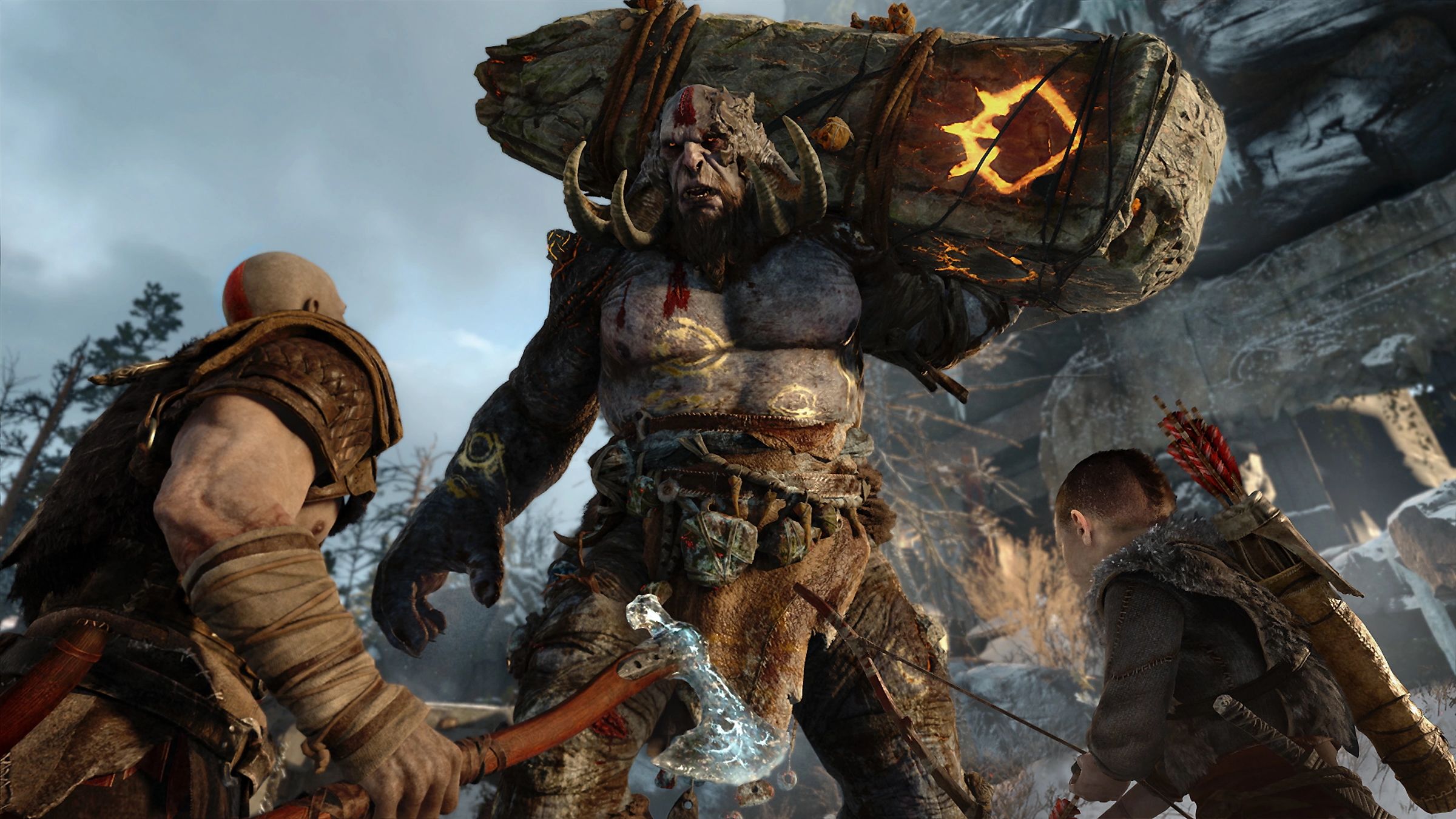 Kratos and his son standing off with a large monster in God of War.